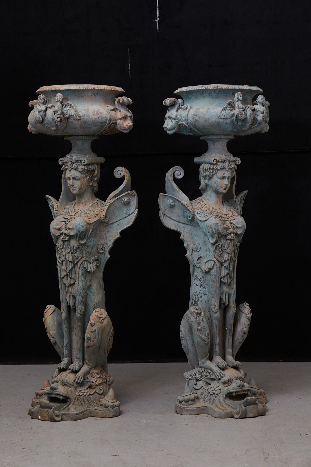 A pair of very rare and very tall (58 inches high) pair of patinated cast iron planters or urns, showing mythical creatures, chimeres, half-human, half-animal. Great details and patina.
Diameter opening 13 inches.
          