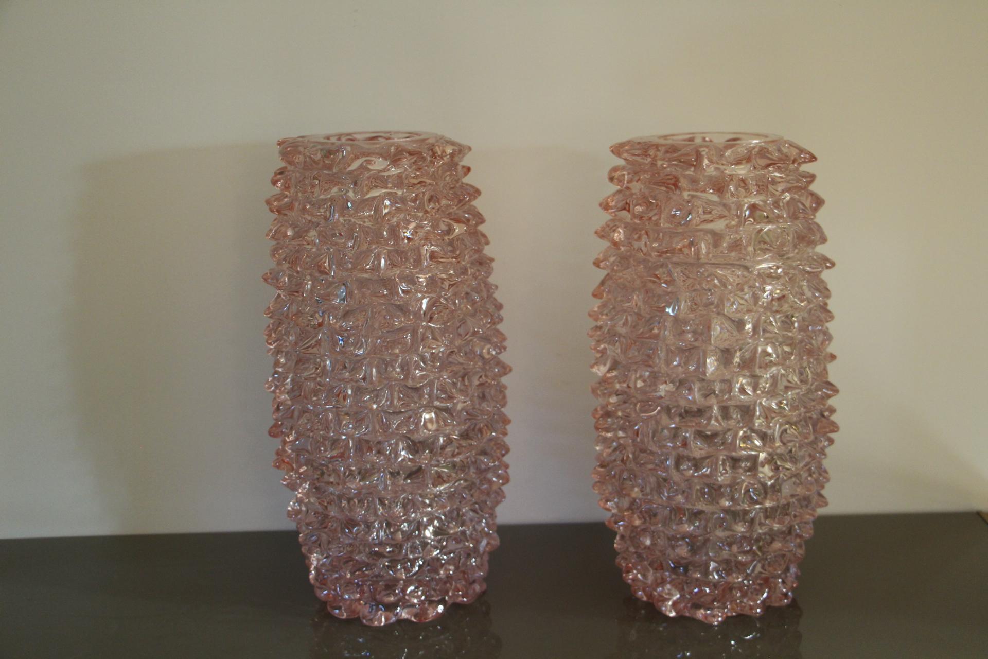 A spectacular pair of Venetian vases, imposing size in very delicate pink color blown Murano glass, hand decorated with the technique rostrato: spikes of glass individually pulled in relief.
Thick walled casing glass produces a lot of iridescent
