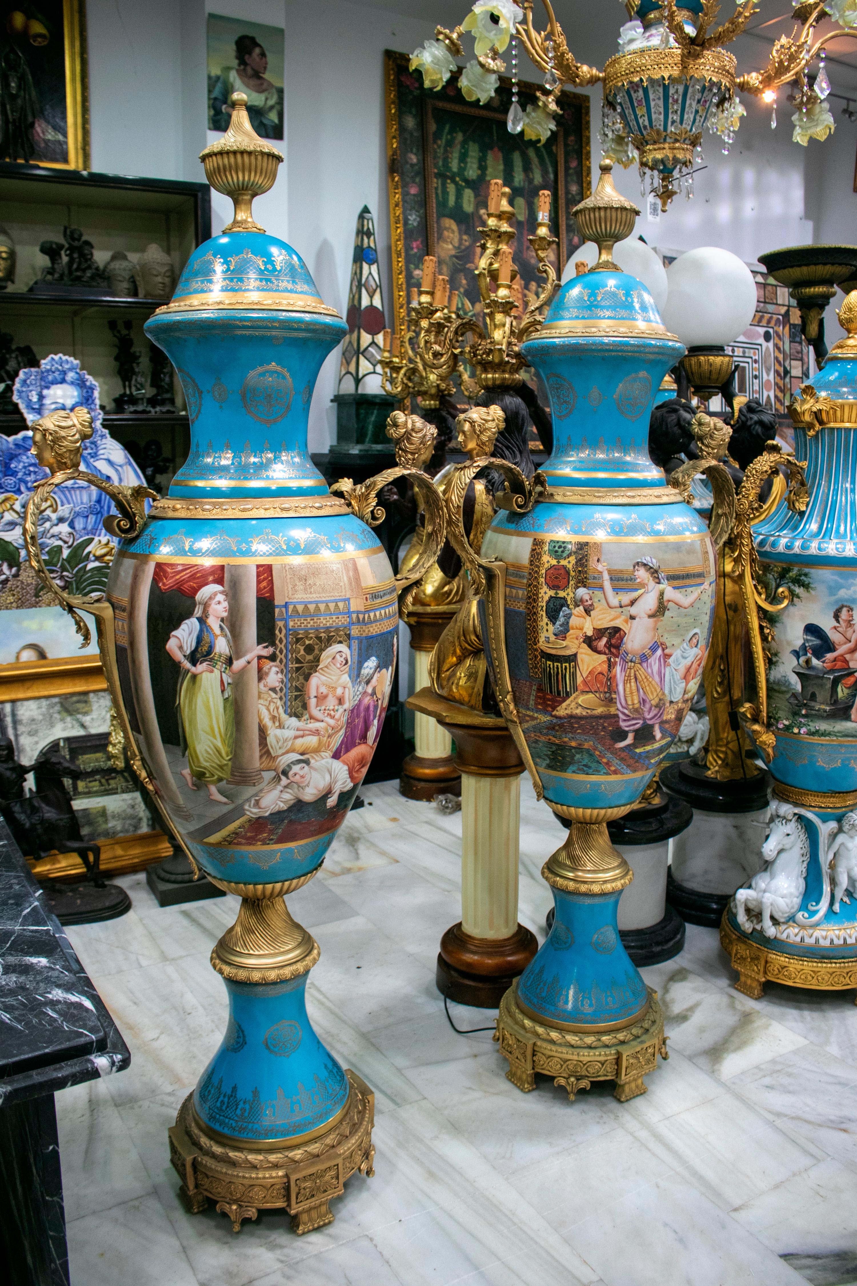 Pair of tall porcelain urns in Luis XV style, with hand painted Orientalist harem scenes.

 
