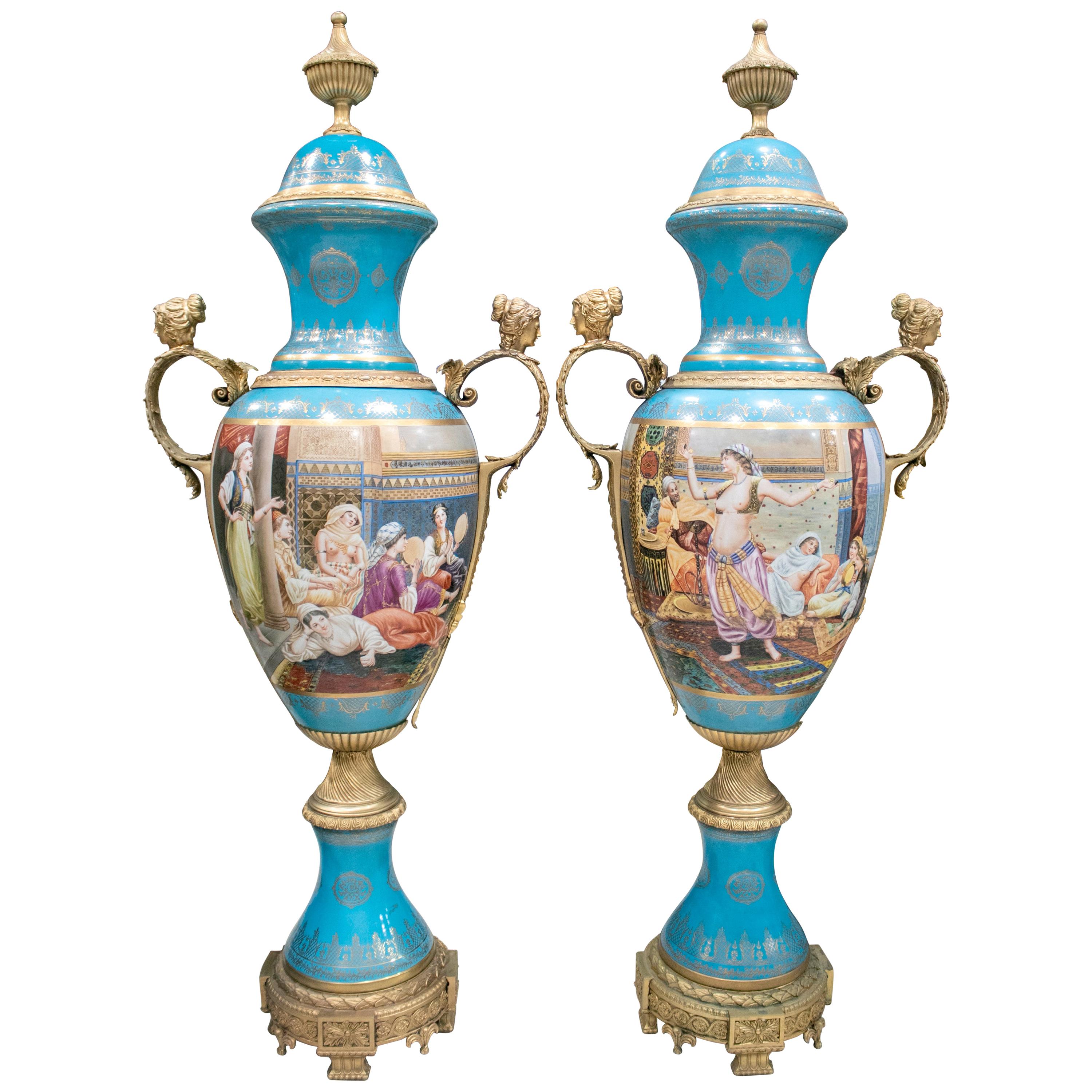 Pair of Tall Porcelain Urns Hand Painted with Orientalist Harem Scenes For Sale