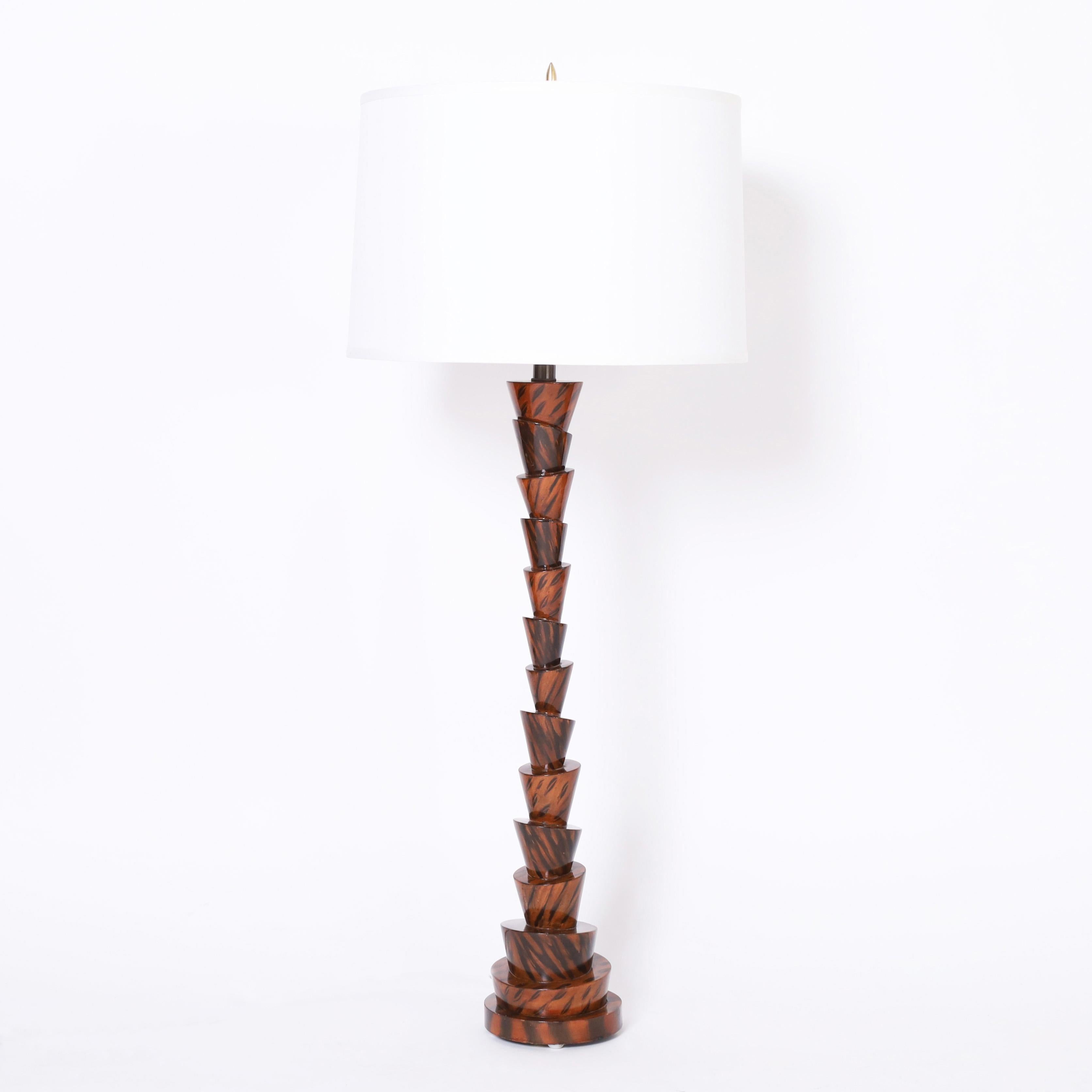 Unusual pair of table lamps crafted in composition in an eccentric form with a hand decorated faux wood finish.