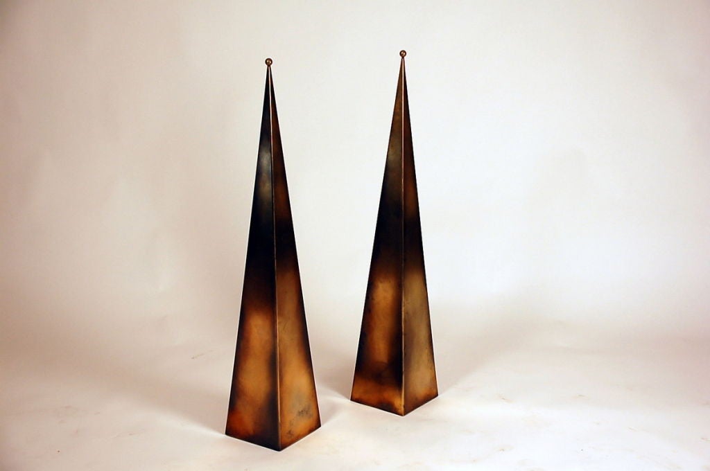 Pair of tall 'Pyramide' patinated brass console or floor lamps by Design Frères. The light source is concealed inside the pyramid base, illuminating the surface behind. Unique design.

Also available in natural brass (as seen on the in situ