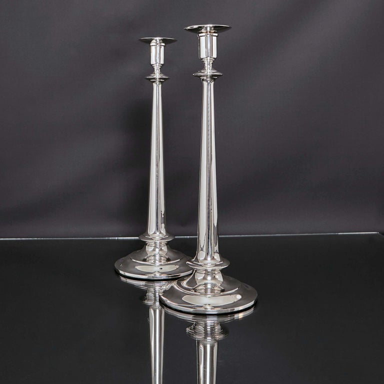 This unusually tall and elegant pair of silver candlesticks was made by the eminent American silversmith Gorham & Co in Rhode Island. With simple domed round bases, supporting long slender tapering stems, round capitals and removable nozzles, this