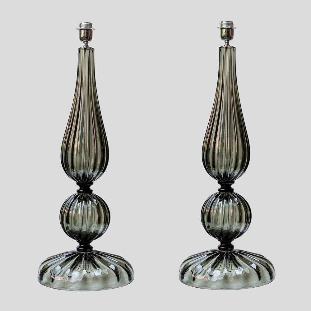 Un par de lámparas de mesa altas, diseño italiano soplado a mano de cristal de Murano gris humo con  un diseño de cinta de Alberto Dona

Se vende con pantallas