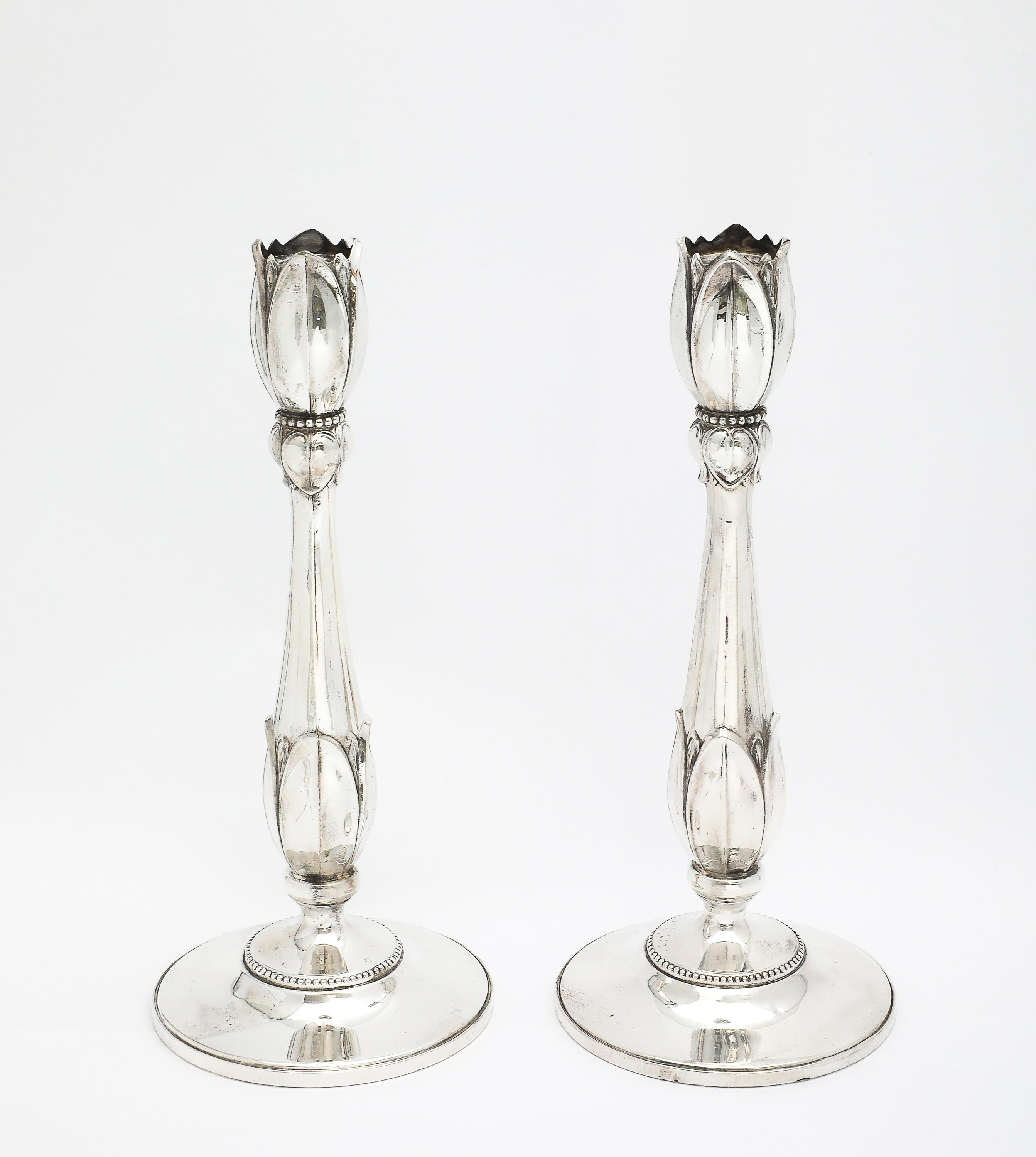 Pair of tall, sterling silver, Art Nouveau-Style, flower-form candlesticks, Fisher Silver Co., Jersey City, New Jersey, Ca. 1935. Beautifully and gracefully designed so that each candlestick appears to be a flower within a flower. Each candlestick