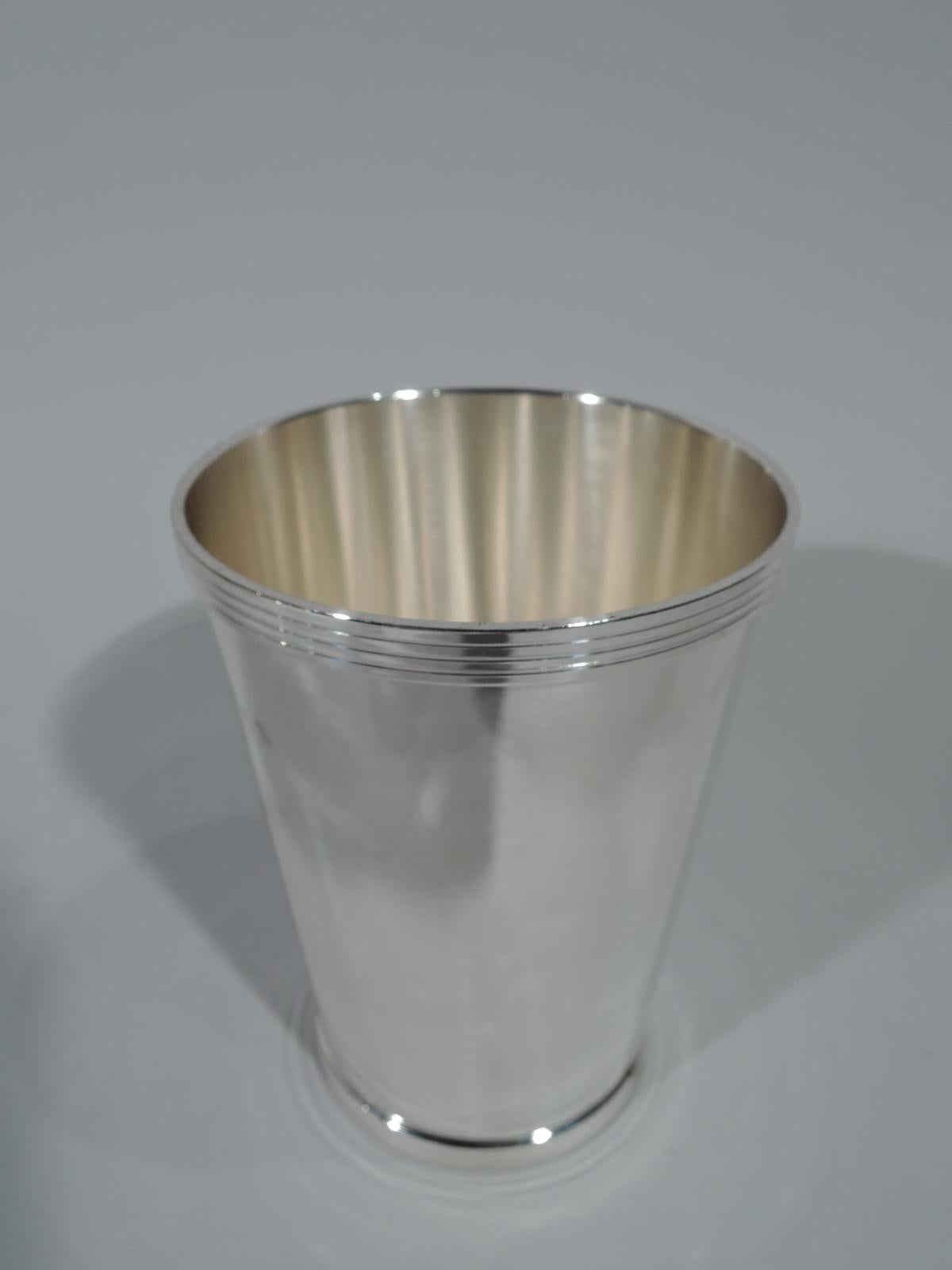 Pair of sterling silver mint julep cups. Made by Fisher by Jersey city. Tall and traditional form with reeded rim and foot. Hallmark includes no. 52. Total weight: 11.4 troy ounces.