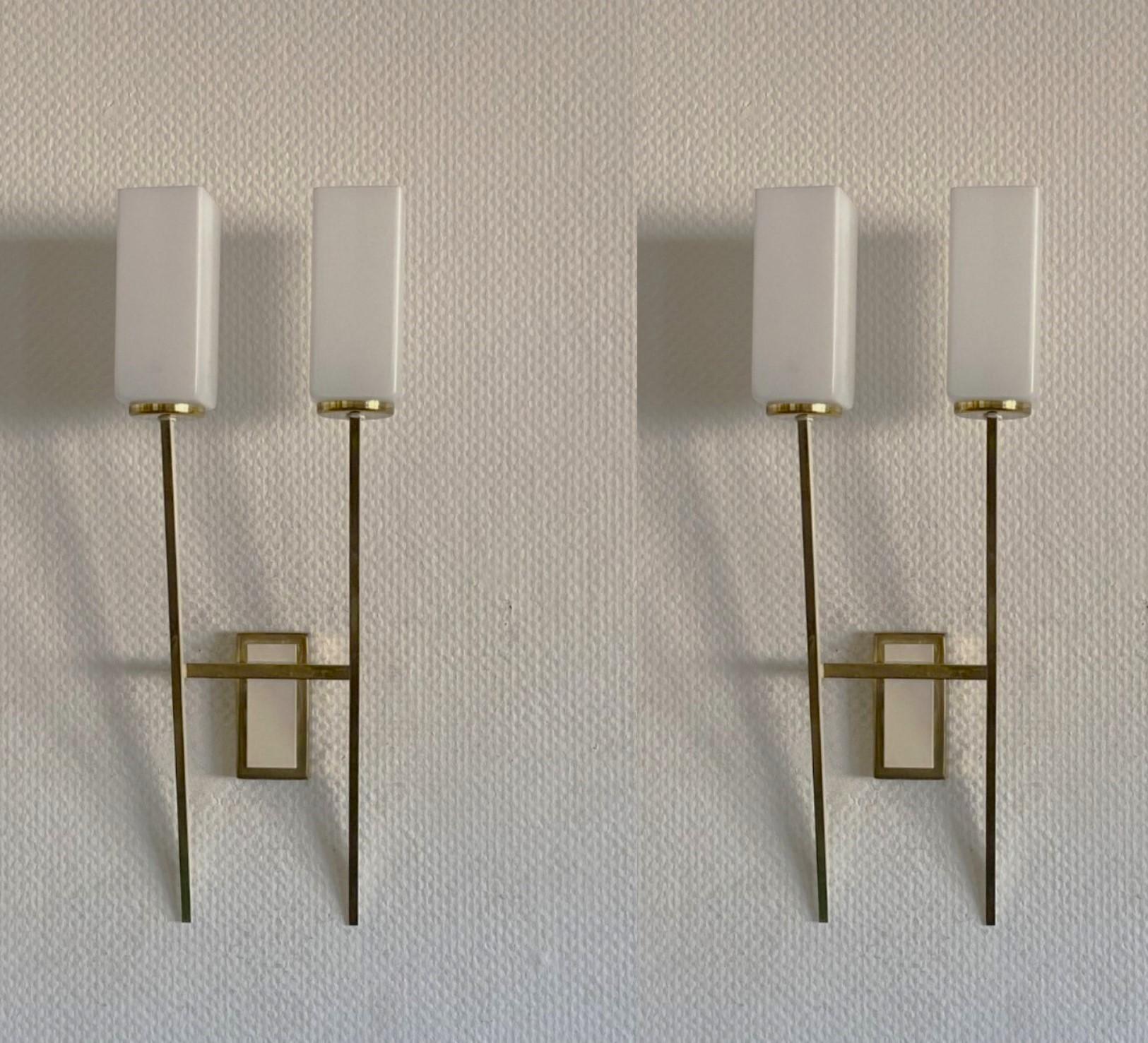 A Pair of tall Stilnovo two-light  wall sconces, Italy, 1960, modernist and clear lines design, brass galery with opaline glass shades - the brass mounts are parcel white enameled. Both sconces in fine vintage condition. Each sconce takes two E14