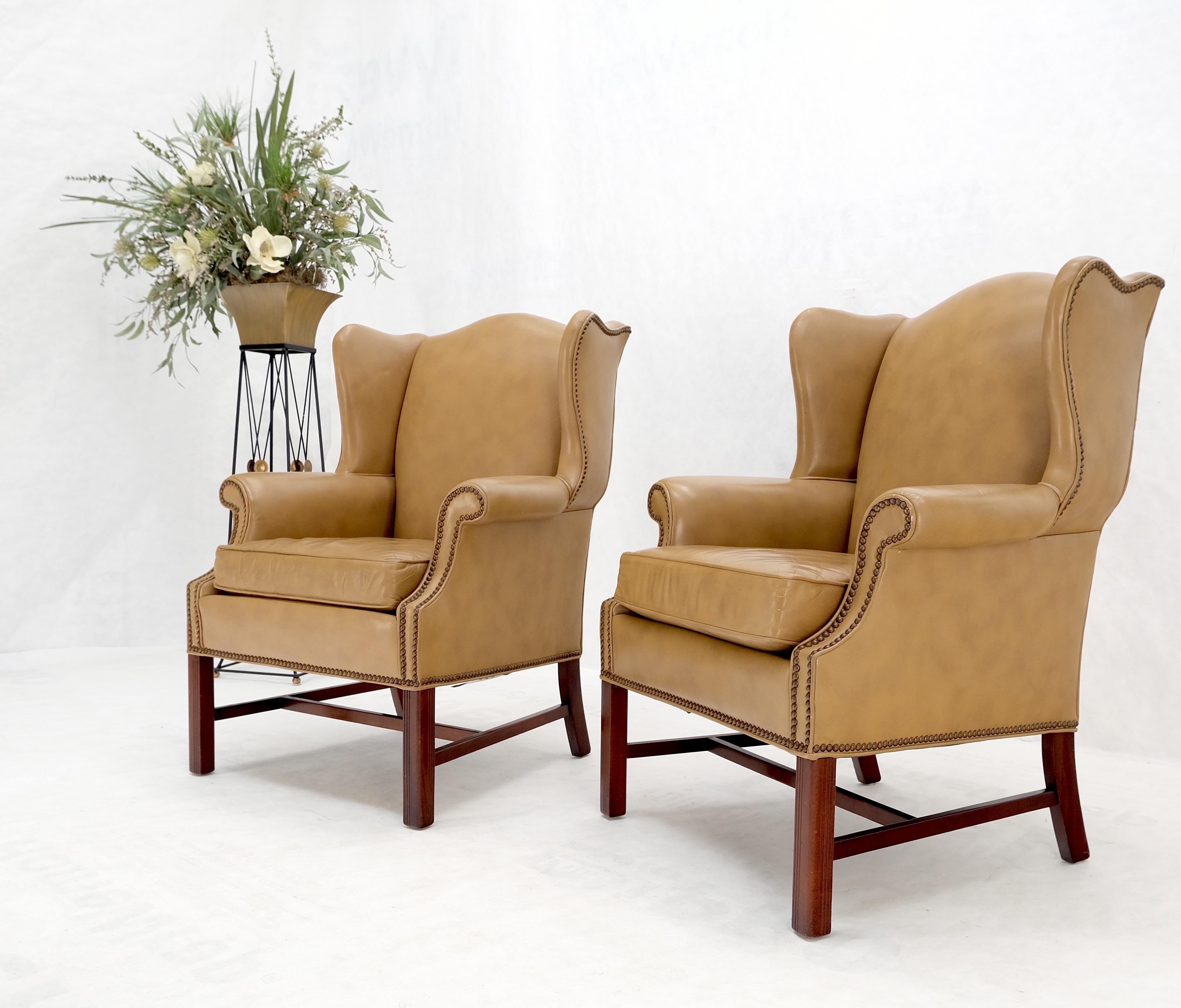 Pair of tall tan leather wing chairs on solid mahogany stretcher base mint!