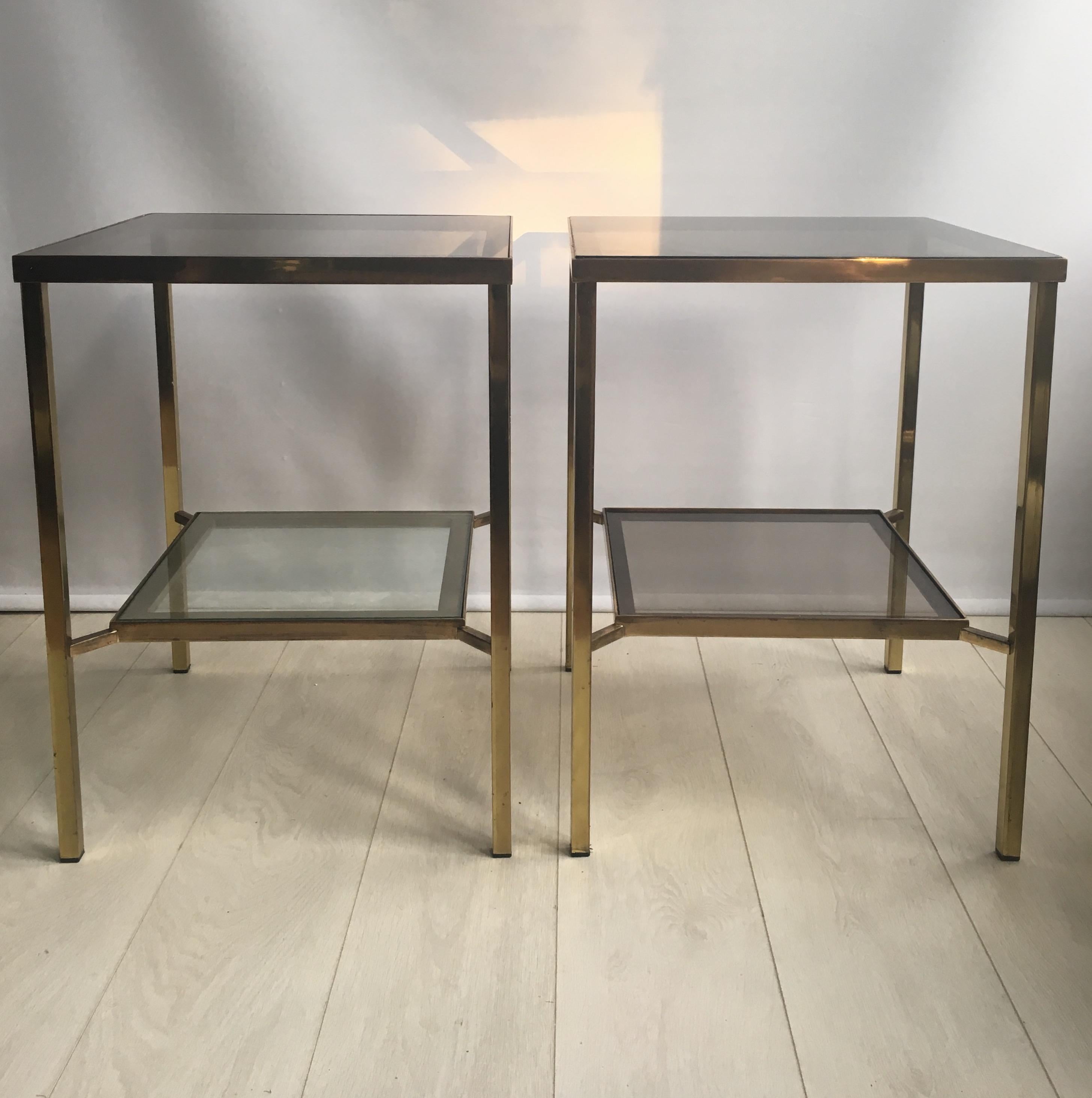Perfect height side tables with polished brass finish and smoked glass shelves.

Very near pair (the top level is approximate 2mm different between the rims) but not noticeable as per images.

Measures: 61 cm tall, 45.5 cm square.