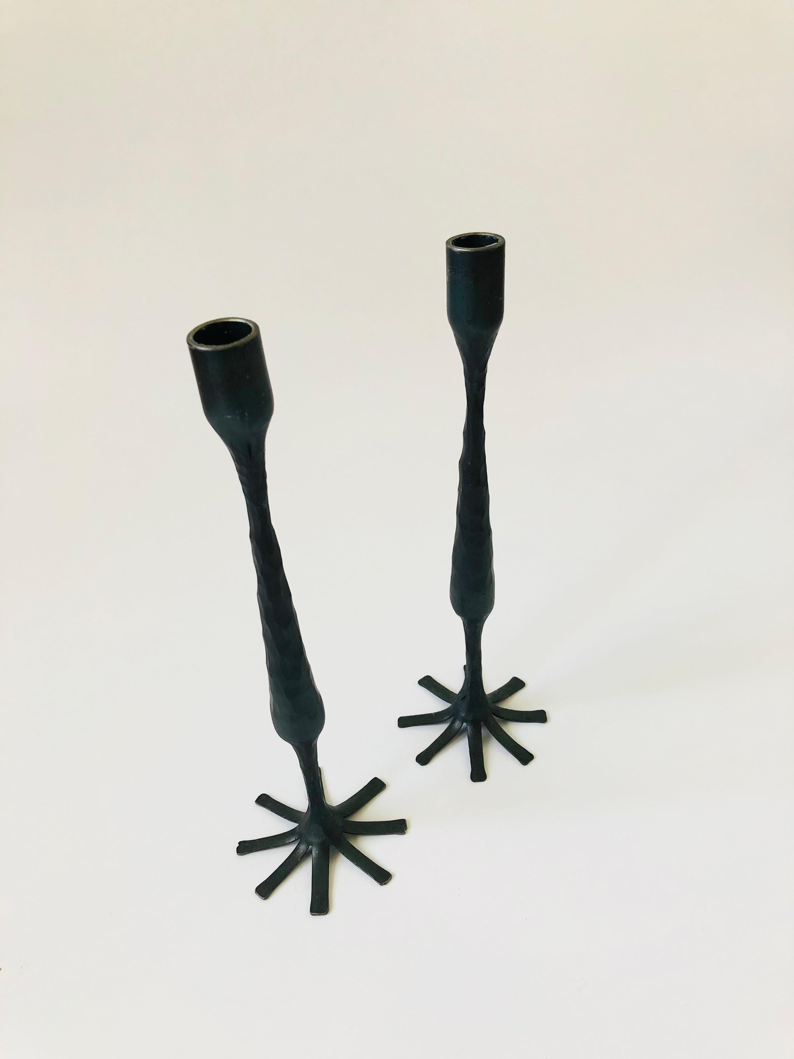 A pair of tall vintage cast iron candle holders. Great brutalist design and texture to the cast iron.
    