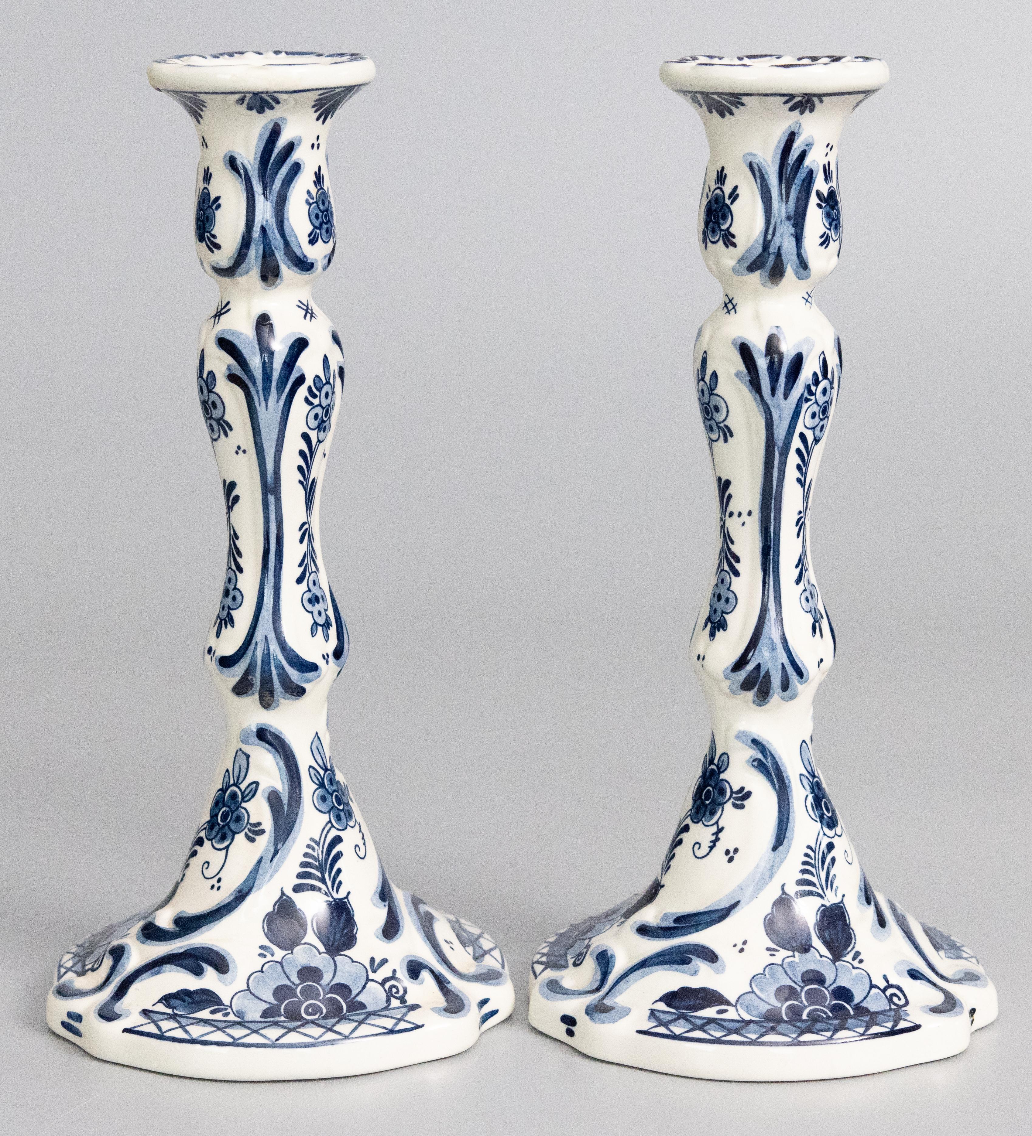 A lovely pair of Mid-Century Dutch Delft faience candlesticks. Marked 