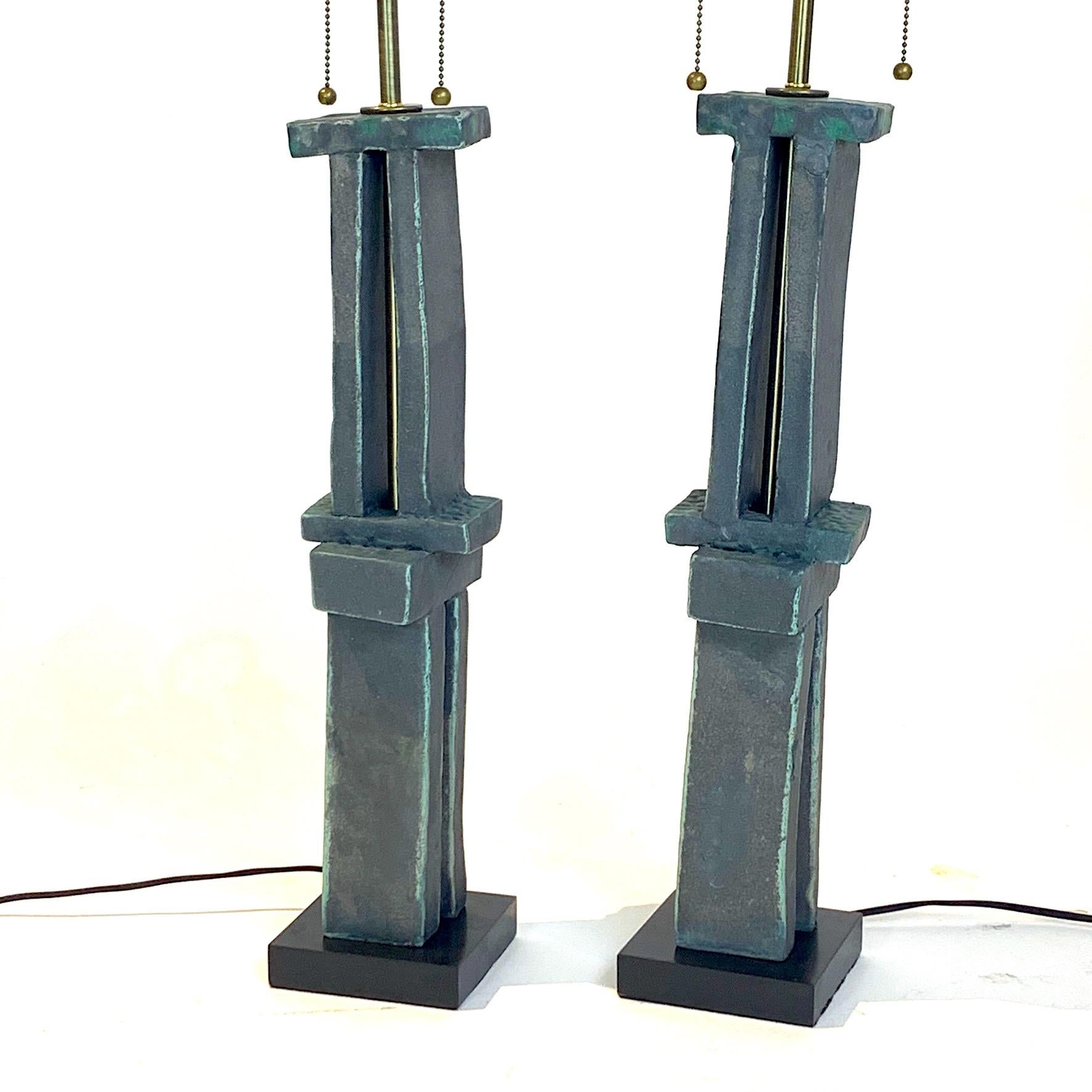 Amazing hand-built sculpture lamps created by Hudson, NY based artist Judy Engel. These stunning weathered bronze glazed totems have been finished with the best lighting hardware in brass with solid wood bases and cloth covered wiring. Absolutely