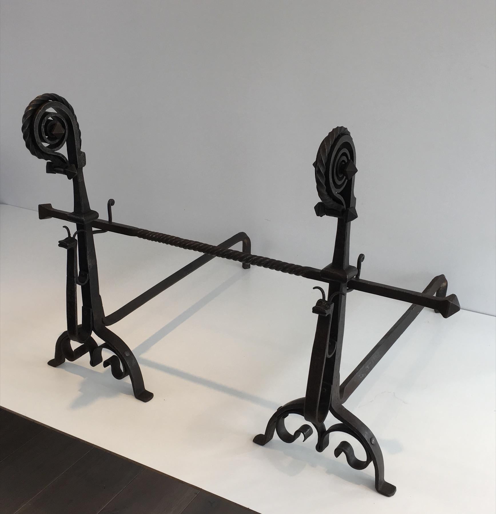 This pair of tall andirons showing a snaill is made of wrought iron. This is an exceptional wrought iron work. This is a French work in the style of Edouard Schenck. Circa 1900