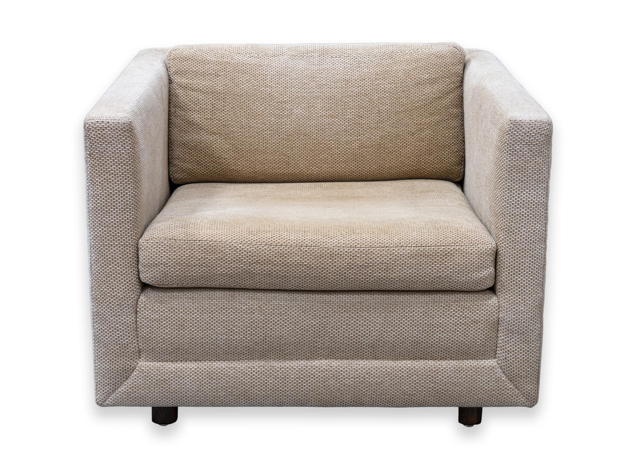 A pair of Brickell cube chairs. A lovely pair of cube chairs, a classic, timeless design. These chairs feature a muted brown/tan fabric with nice texture. The seat cushions are removable for easier cleaning. They are supported with their wood frame