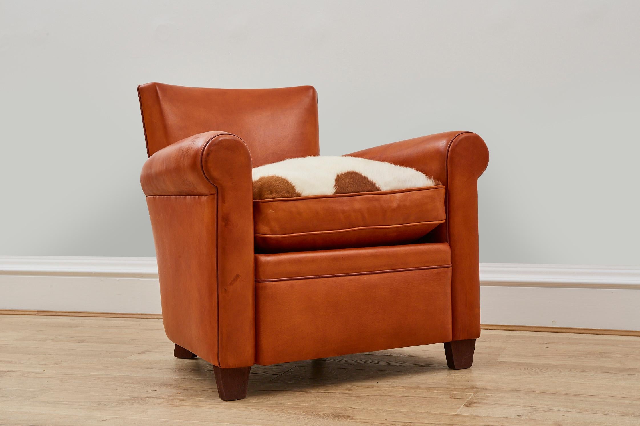 British Pair of Tan Leather Club Chair with Cow Skin Cushions