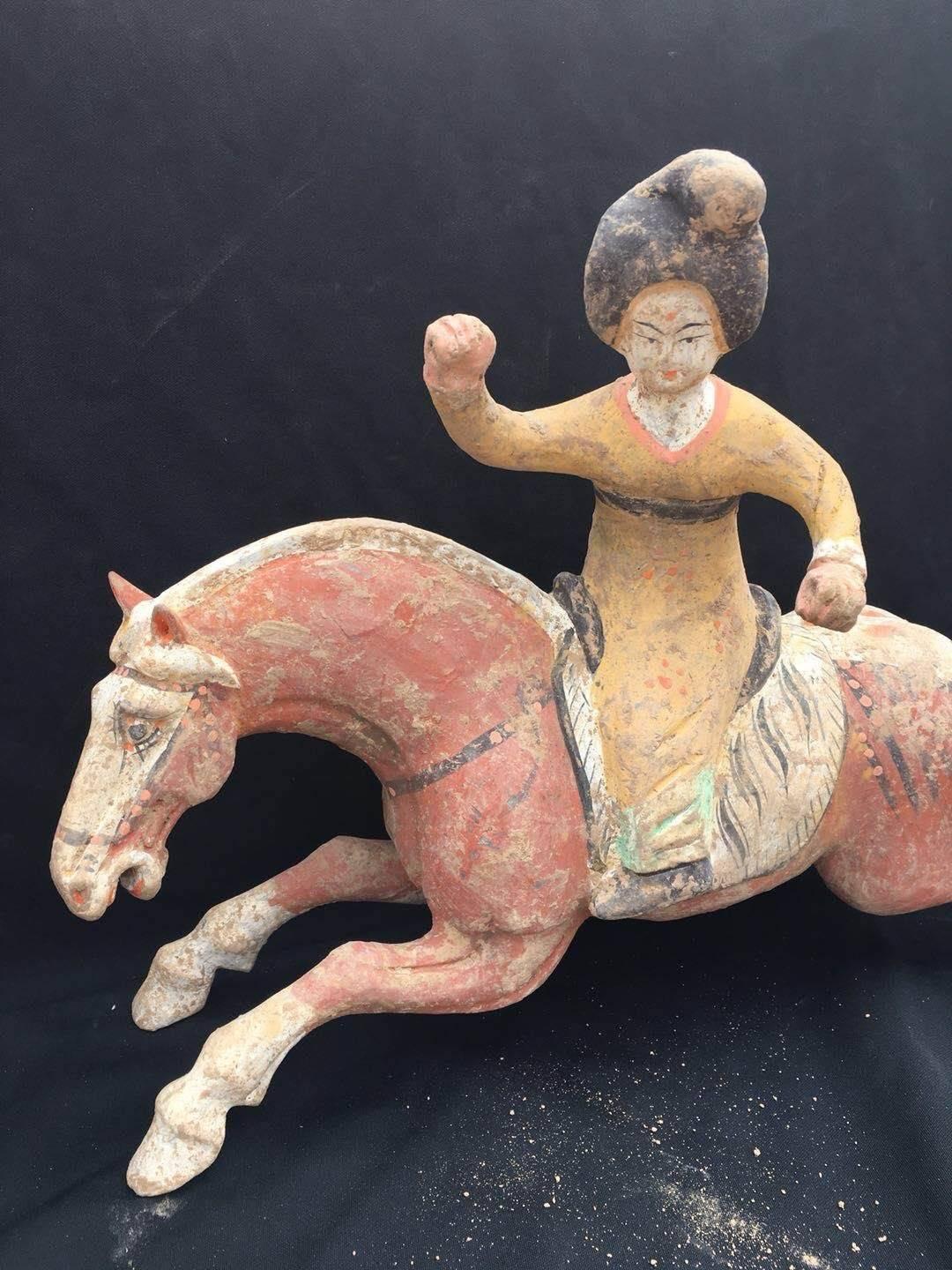 A rare pair of female court ladies playing polo upon tang dynasty horses.
Lively characterization of 8th century craftsmanship.
Measurements: approximate 12” tall x 16” length.
TL tested from Oxford.