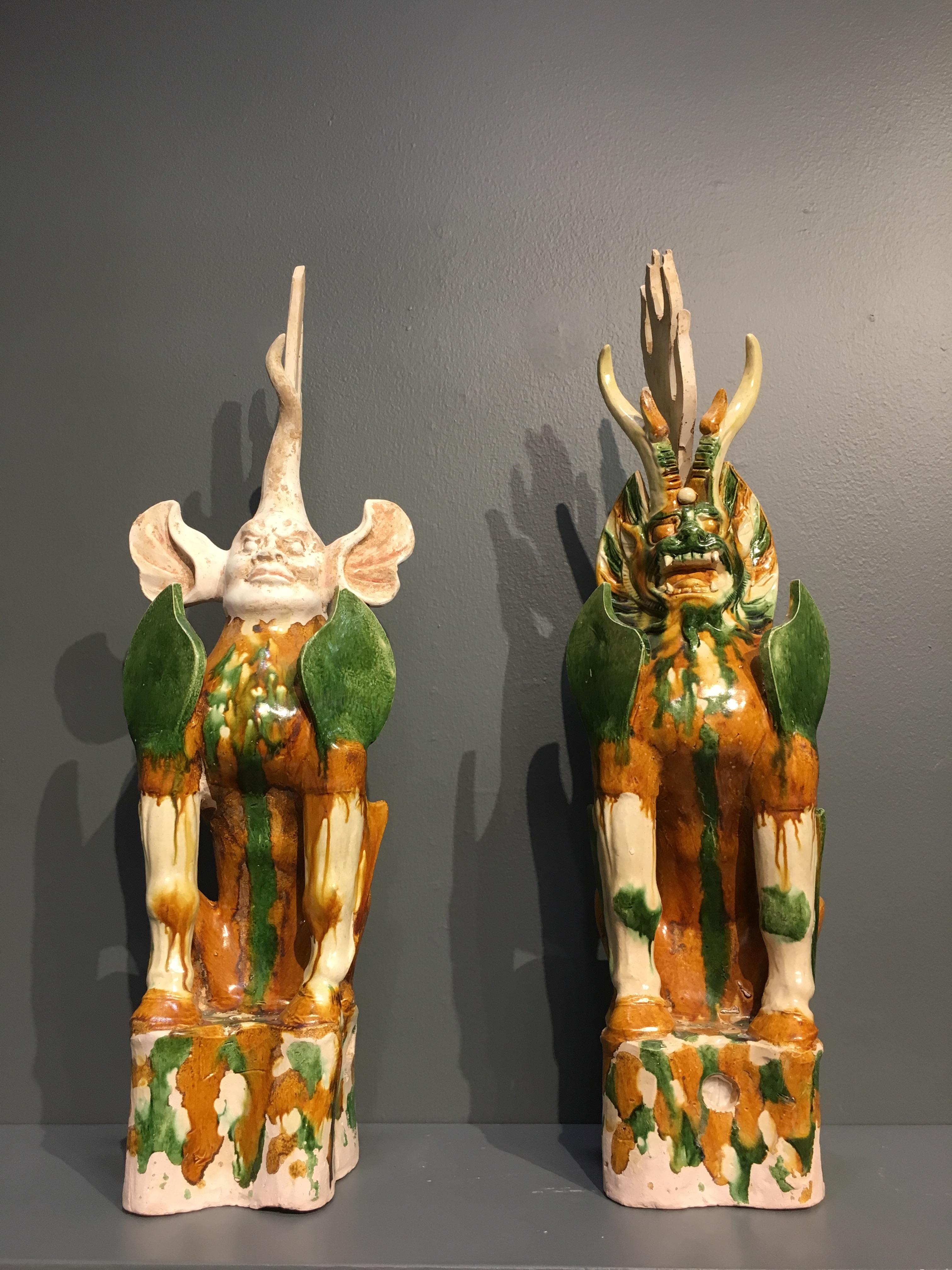 A fantastic and powerful pair of Chinese Tang Dynasty three-color (sancai) glazed zhenmushou, tomb guardian figures, late 7th or early 8th century. TL tested by Oxford Authentication, 1998. 

The fierce, mythical creatures are masterfully composed.