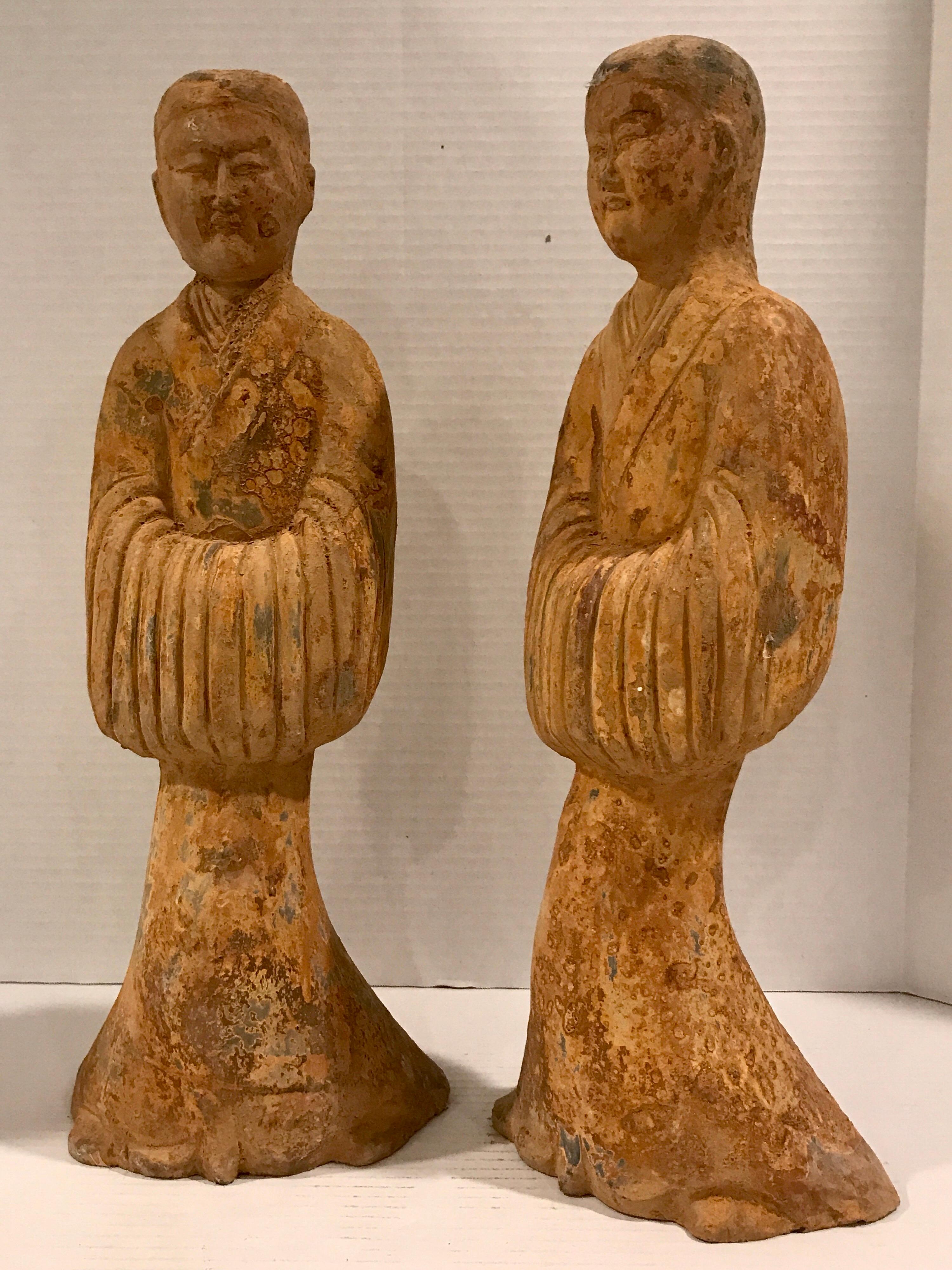 Pair of Tang style terracotta tomb attendants, each one a standing robed figure with crossed arms, great size, scale and patina.