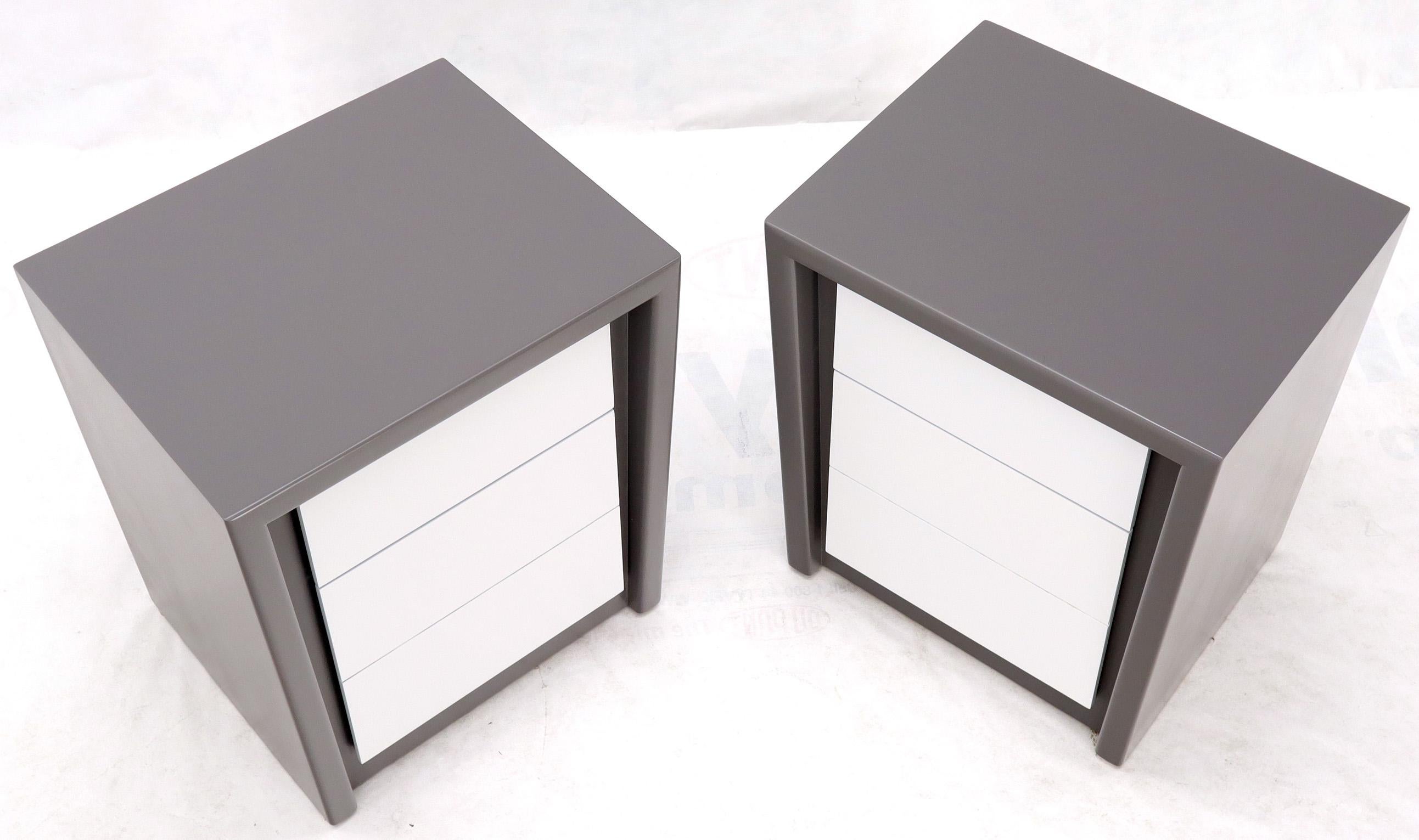 Pair of Mid-Century Modern two-tone grey and white lacquered nightstands or side tables. Nice tempered lines clean form cabinets. Solid and steady construction.