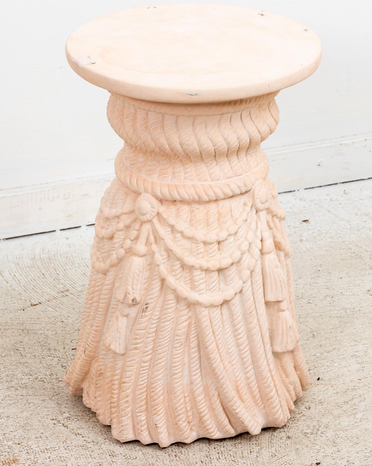 A pair of Hollywood Regency style draped rope and tassel motif plaster side tables. Highly decorative with original sand color matte painted finish exhibiting a beautiful vintage patina. Great as side tables, drinks tables, stools, plant stands or
