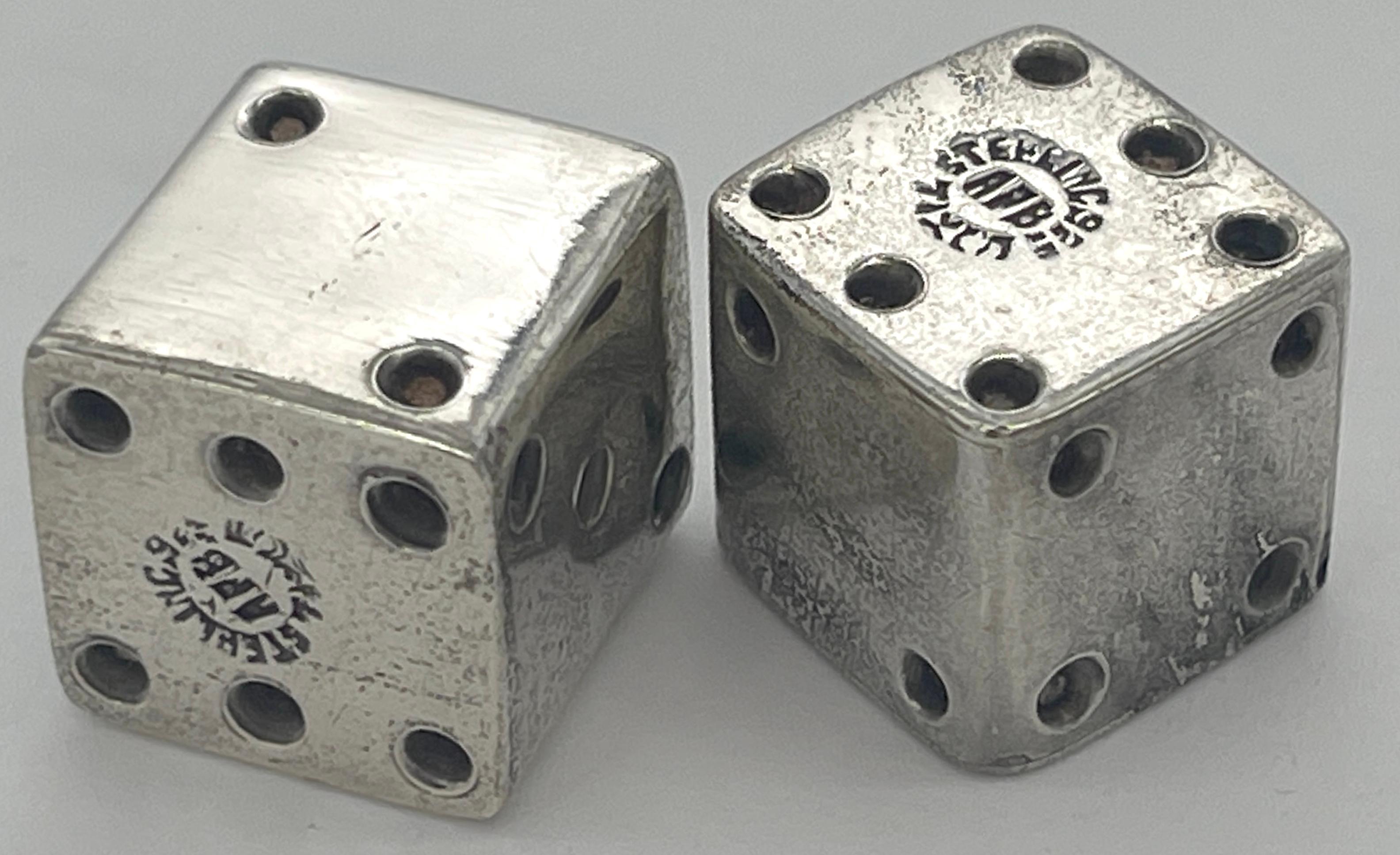 Pair of Taxco School Sterling Silver Dice, Mexico circa 1960s 
Each one is hallmarked with the makers mark, .925 and Taxco.

Elevate your gaming experience with this exquisite pair of Taxco School Sterling Silver Dice, crafted in Mexico circa the