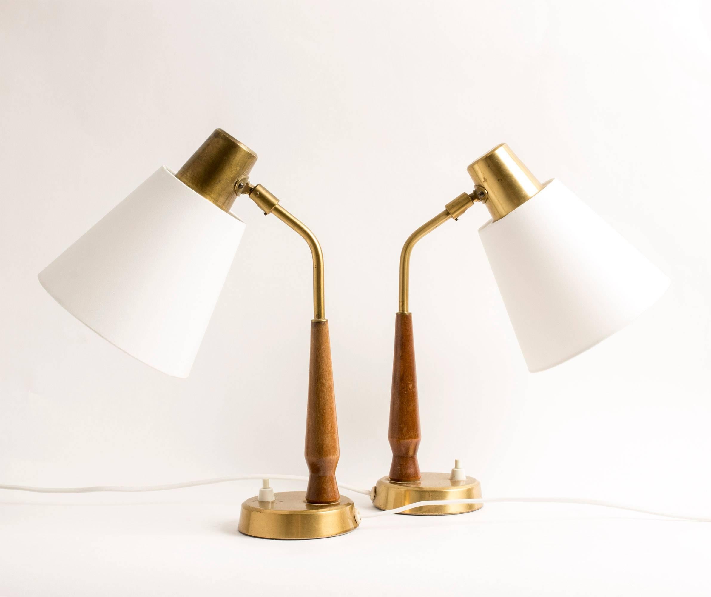 Pair of elegant, small desk or bedside lamps by Hans Bergström, made from brass with teak handles.