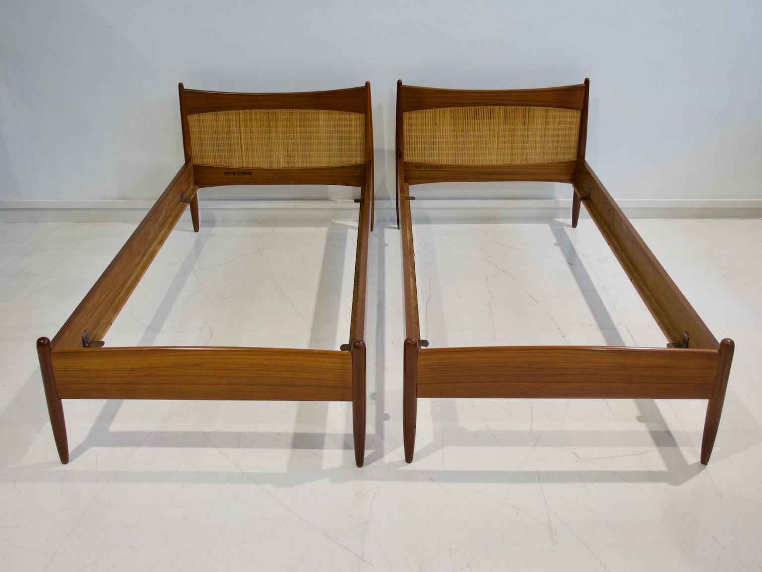 Pair of teak wood bed frames with rattan headboard from the 1950s. Designed by Børge Mogensen and manufactured in Denmark. Stamped by maker. Easy to dismantle for shipping and then assemble. Beautiful pieces for guest or children bedrooms.