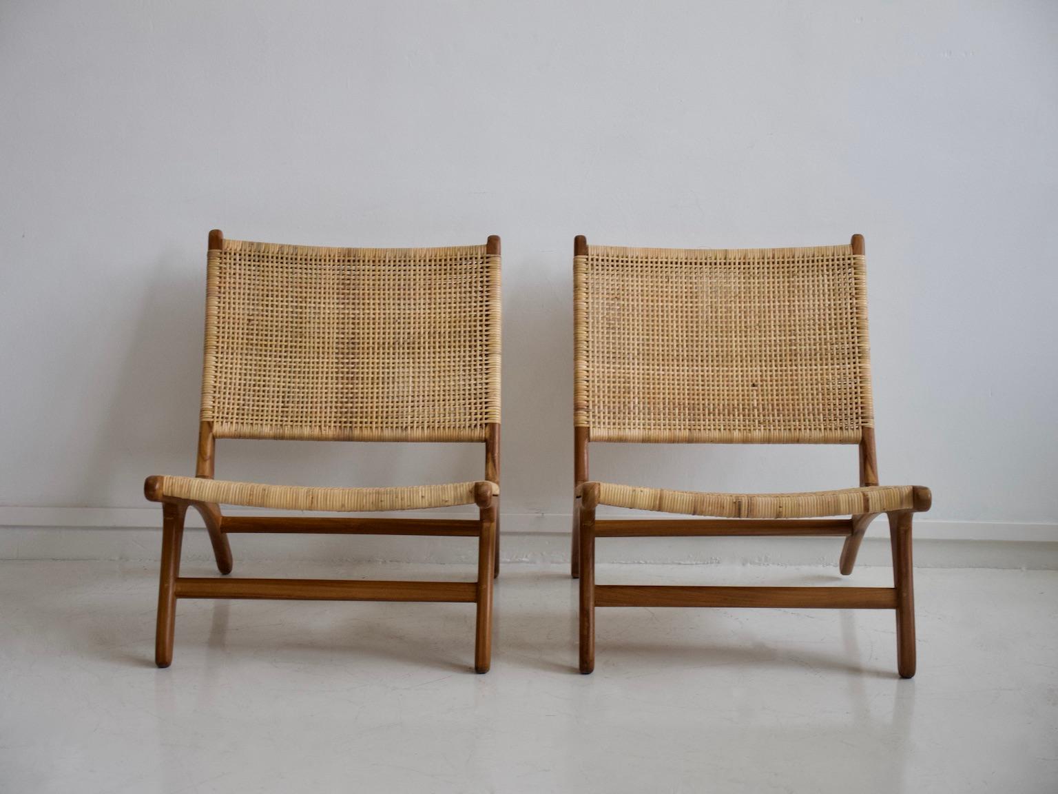 Pair of lounge chairs with teak frame and braided cane seat and back. Slightly backward tilting back. Minor scratches on the frame.