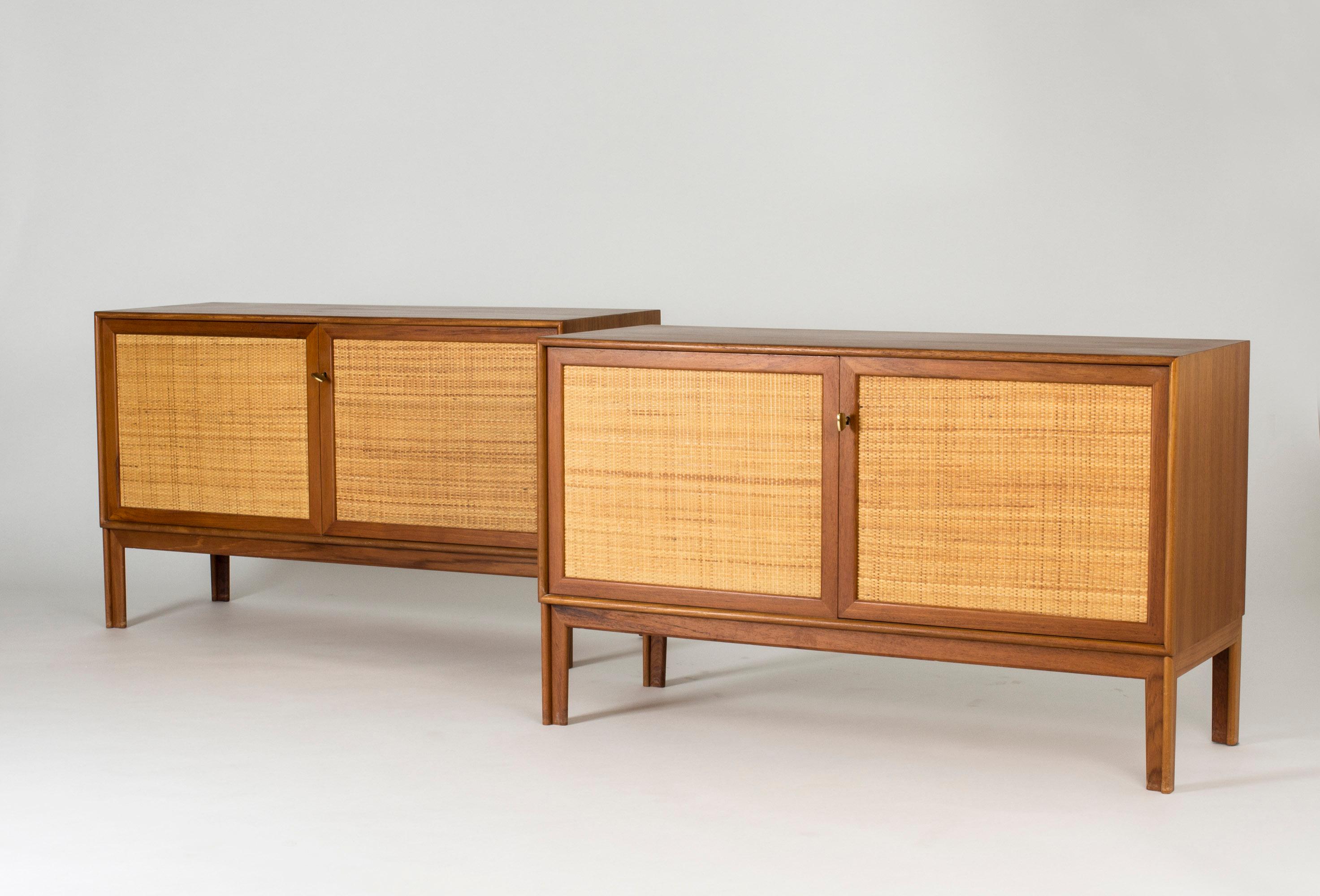 Pair of teak sideboards with beautiful rattan fronts, designed by Alf Svensson for Bjästa. Two shelves inside each sideboard separated by a wall in the center. Cool, large brass keys and nicely sculpted legs. Beautiful material combination.