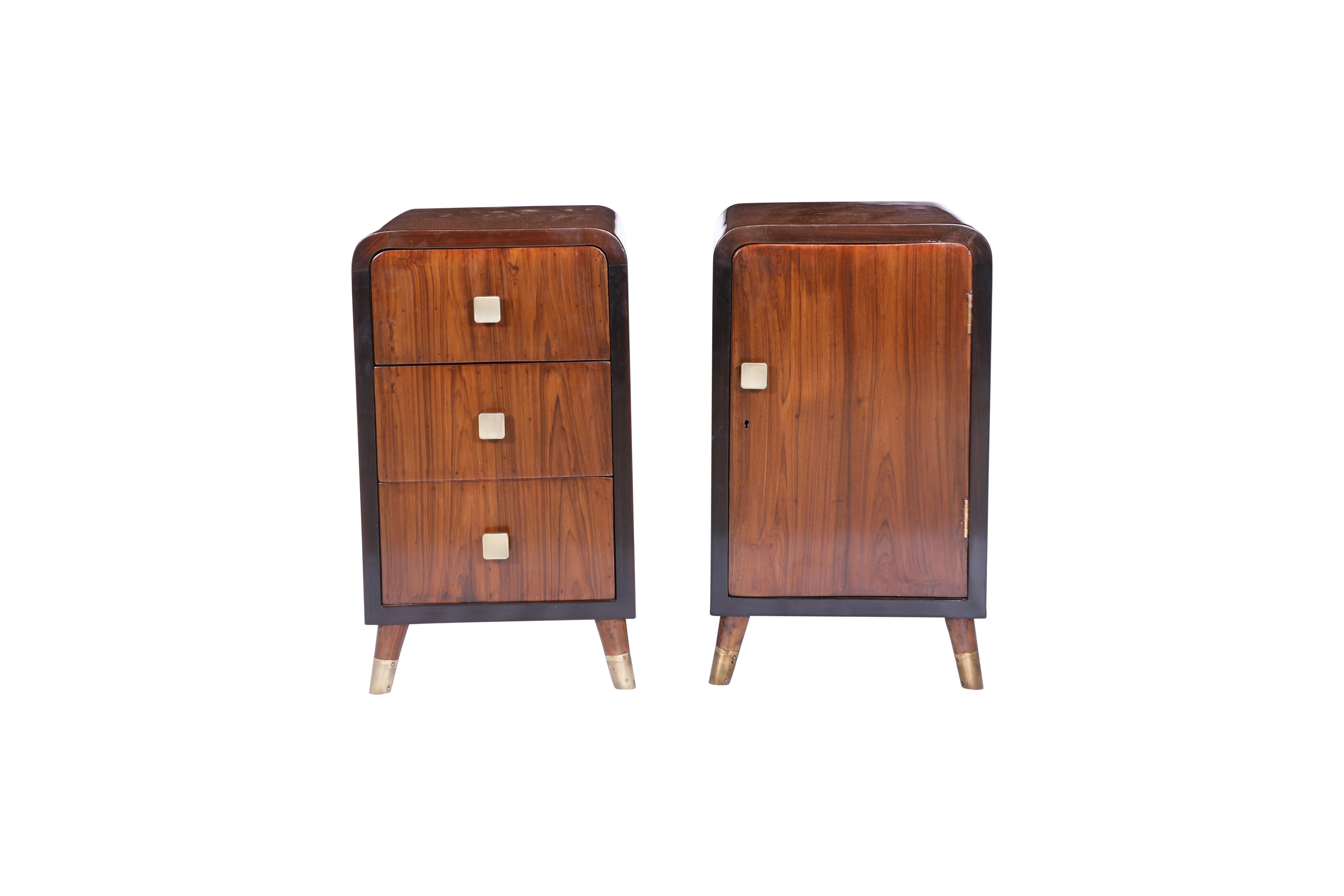 A pair of Mid-Century Modern teak end or side tables.  More like cousins than twins.  One features three front drawers and the other a cabinet with interior shelf.  Rosewood border with brass pulls.  Circa 1970's, refinished.

The Lockhart