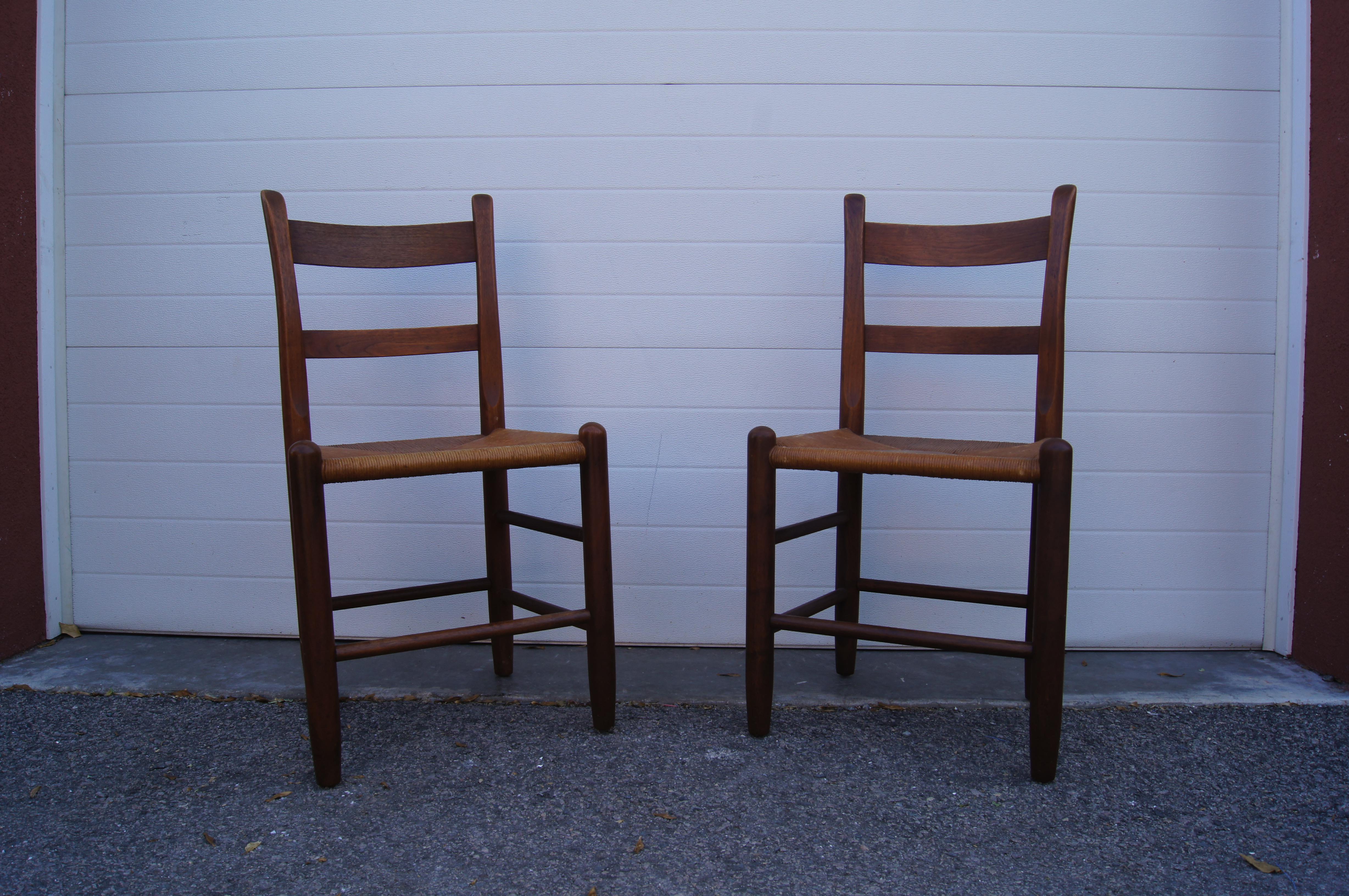 This pair of dining chairs by the Cambridge, Massachusetts, furniture maker Charles Webb features solid teak frames with angled backs and rush seats.
