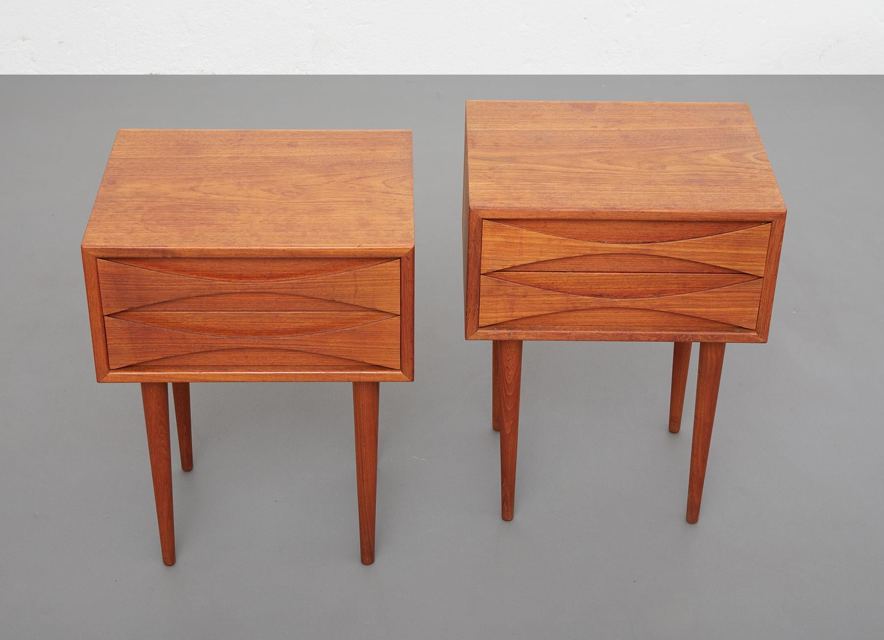 Pair of bedside tables by Danish designer Niels Clausen for NC Mobler, Denmark around 1960

The bedside tables are in teak and are characterized by the elegance of their proportions and shapes. The drawers with their openwork half-moon faces are