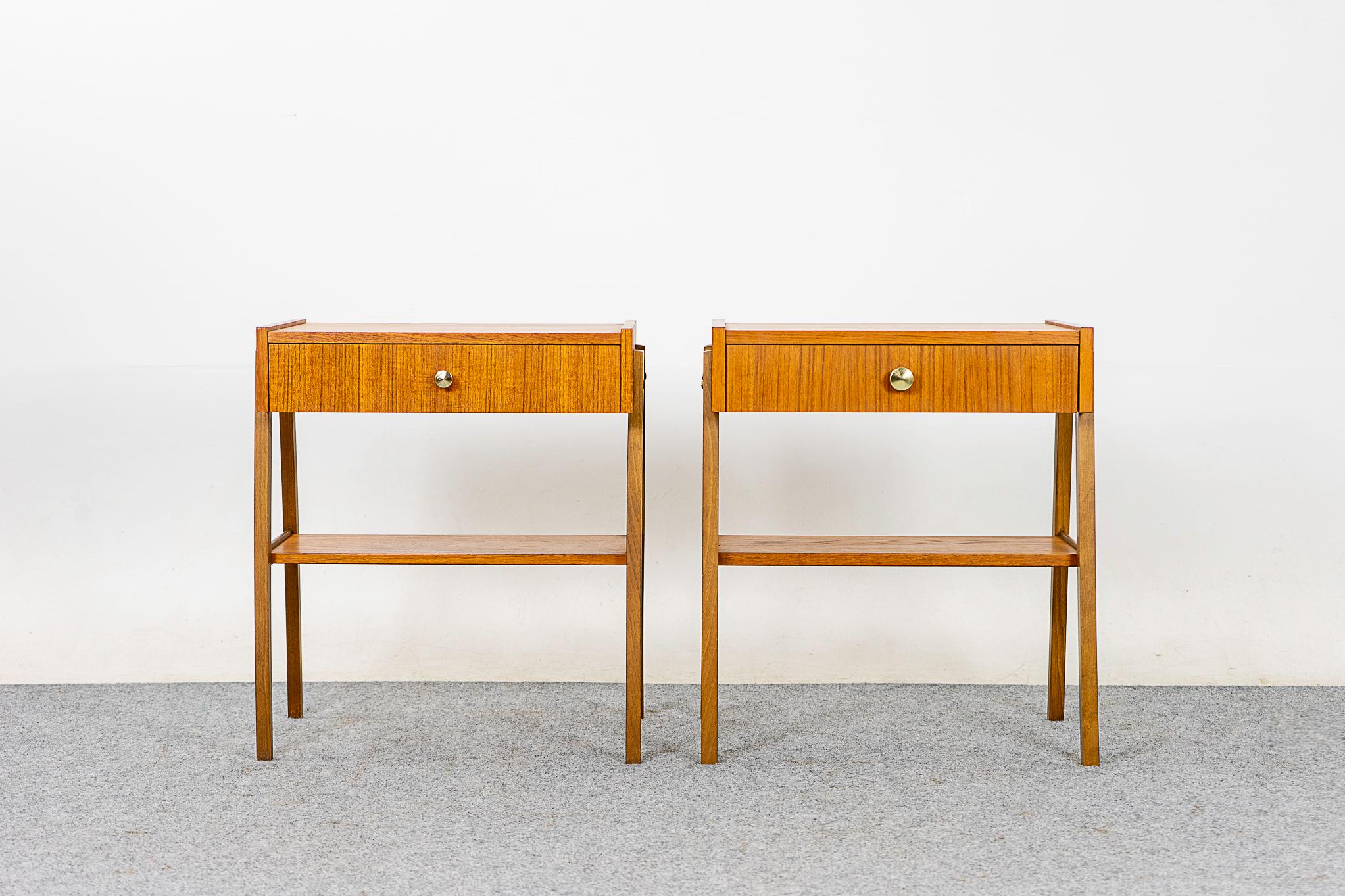 Teak mid-century bedside tables, circa 1960's. Dovetailed drawer offer storage for small items, lower shelf is perfect for your favorite book. 

Please inquire for international and remote shipping rates.