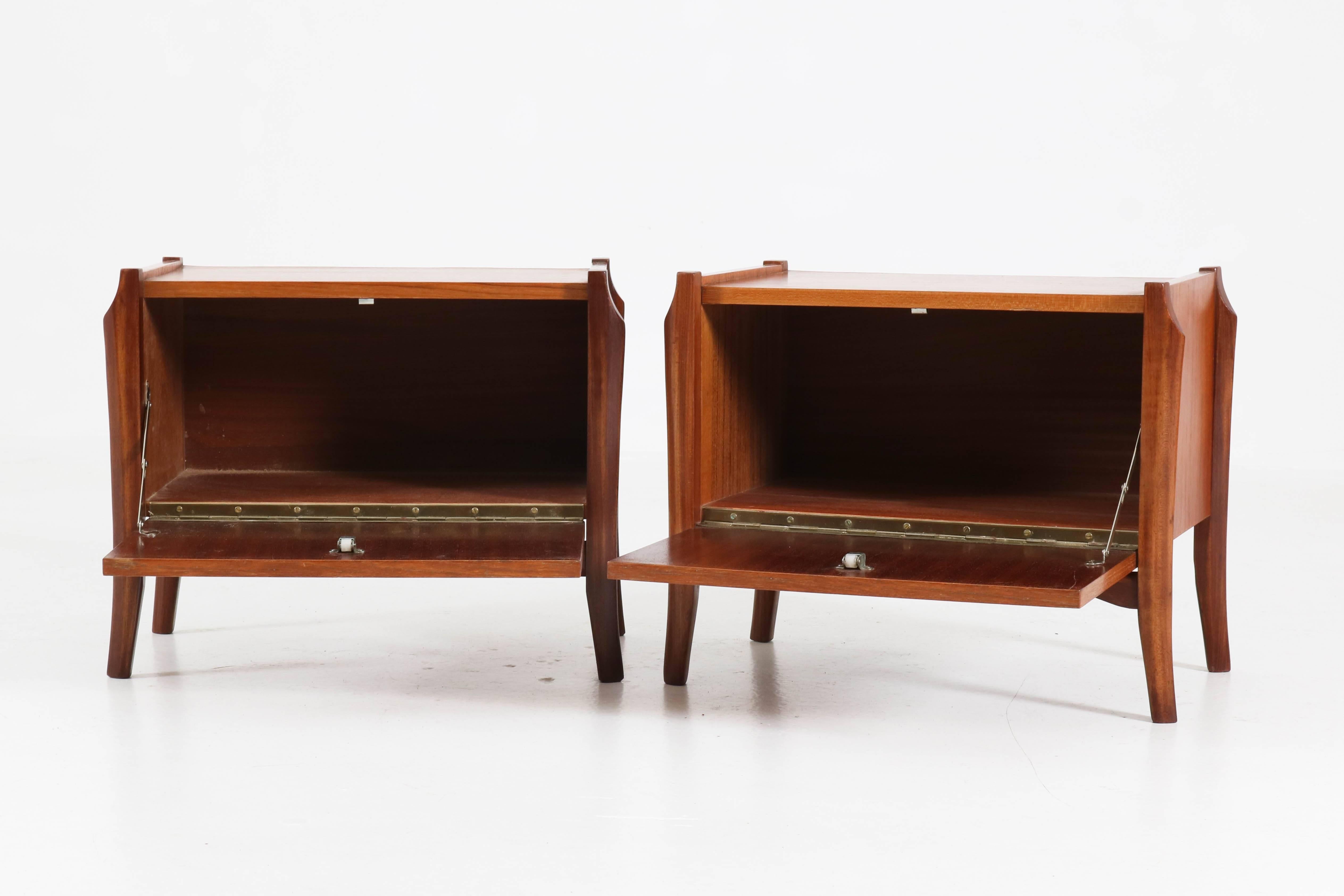 Elegant pair of Dutch Mid-Century Modern bedside tables or nightstands.
Solid teak with teak veneer.
Organic design from the 1960s.
In good original condition with minor wear consistent with age and use,
preserving a beautiful patina.
   