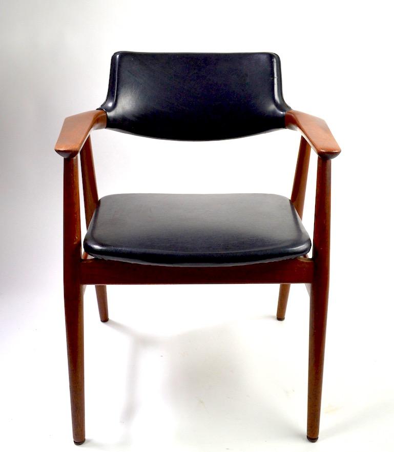 Rare form, teak frame arm chairs with vinyl seats and backs, designed by Grete Jalk. Both chairs are in very fine original condition, one has slight damage to the vinyl seat, as shown,. Measures: Arm H 25 inches x seat H 18 inches. Priced and