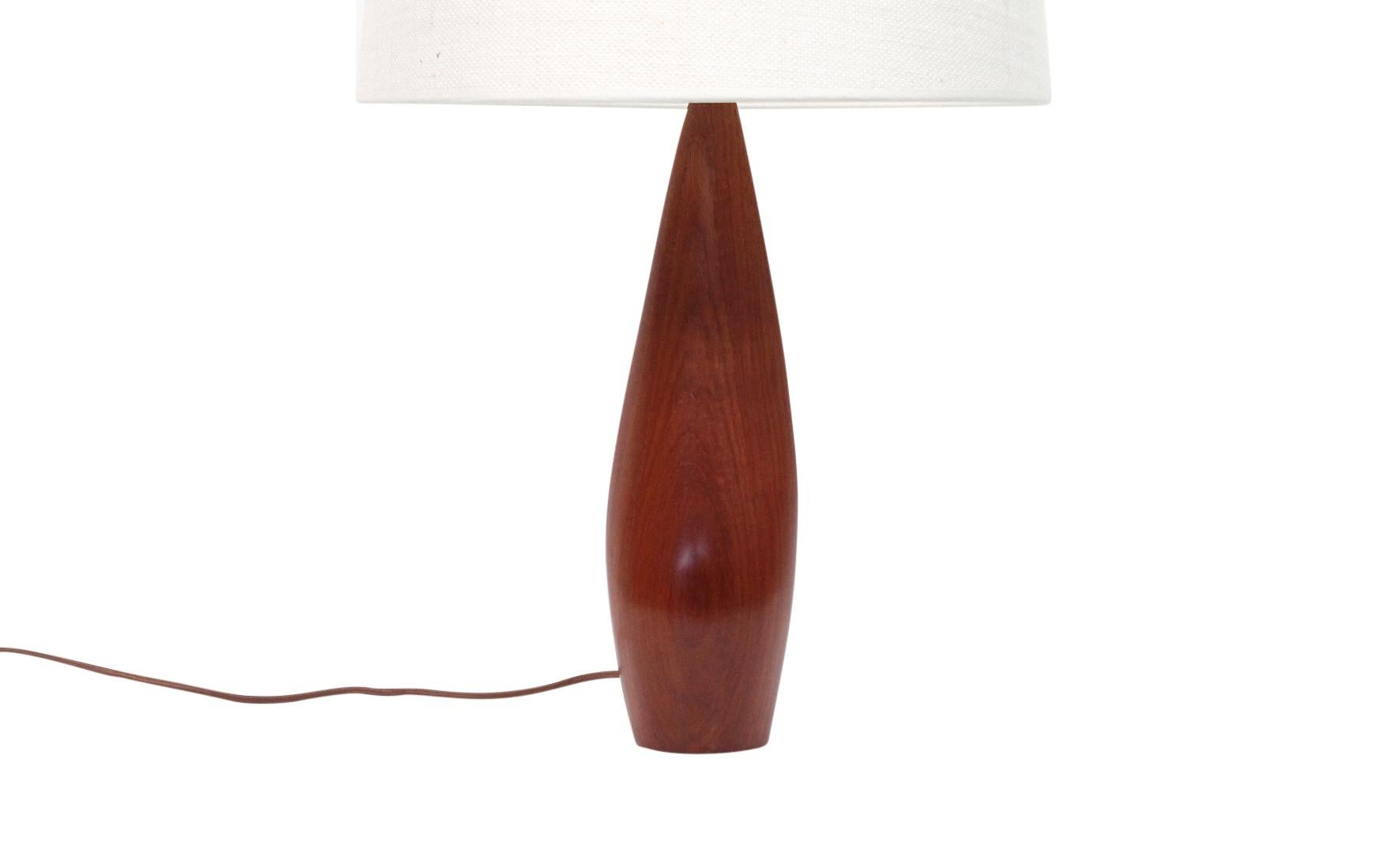 Rare pair of sculptural lamps carved from a single piece of solid teak by Danish designer Ernst Henriksen. Marked 