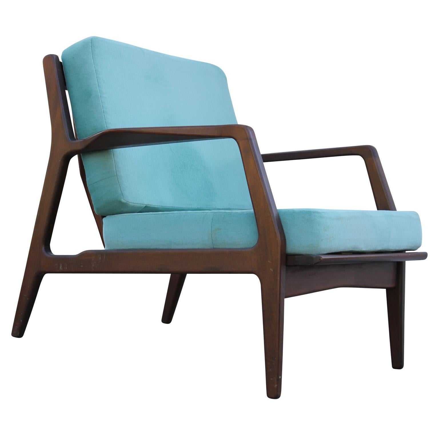 Pair of comfy and beautiful lounge chairs by Ib Kofod Larsen for Selig. They're made from teak wood, and we suggest that the customer reupholsters with COM.