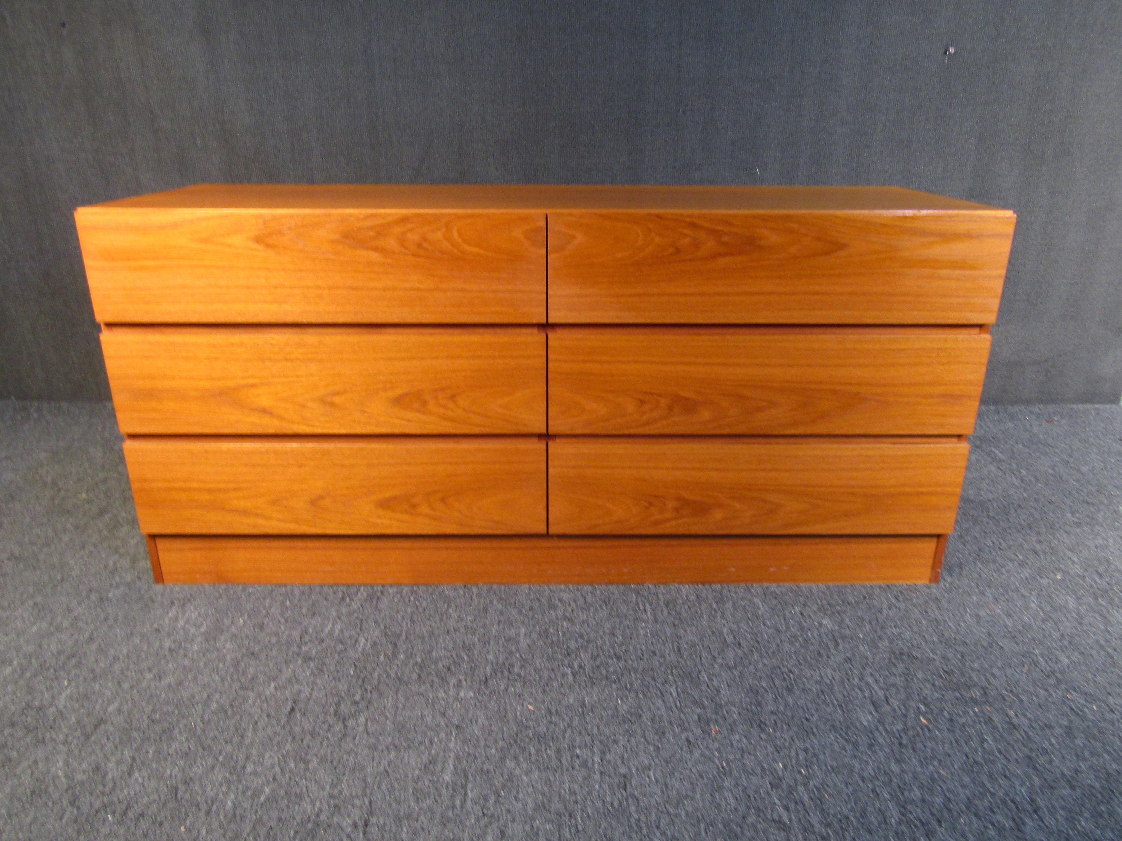 Teak Mid-Century Modern dresser that are sure to bring timeless style to any bedroom. Minimal design, sturdy quality, and plenty of storage make this dresser an elegant and practical addition to any home.