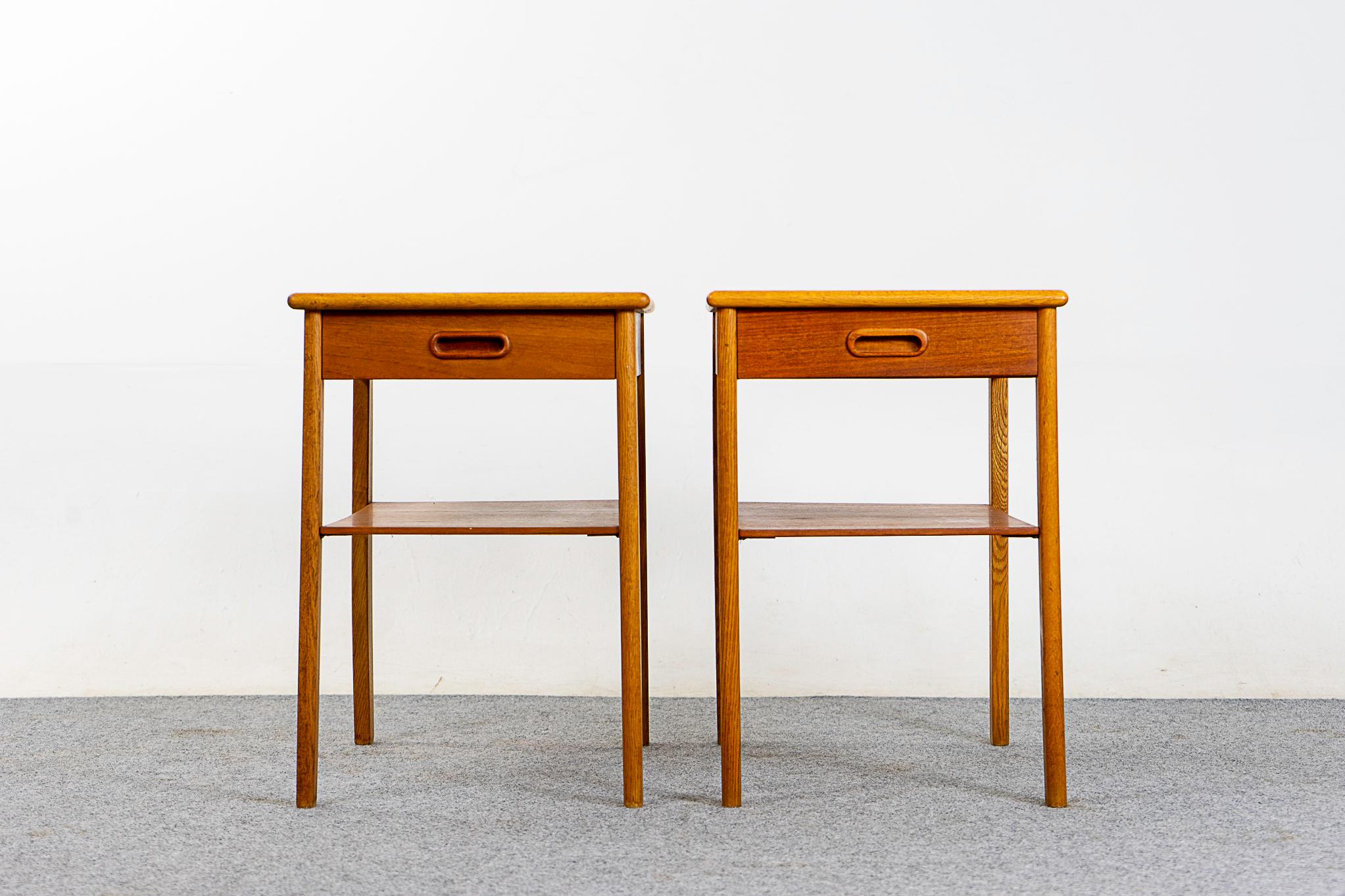 Teak & oak Danish bedside tables, circa 1960s. Beautifully veneered case rests on slender legs. Dovetailed drawer for small items, open shelf is perfect for your favorite book.

Unrestored item, some marks consistent with age, back strip is