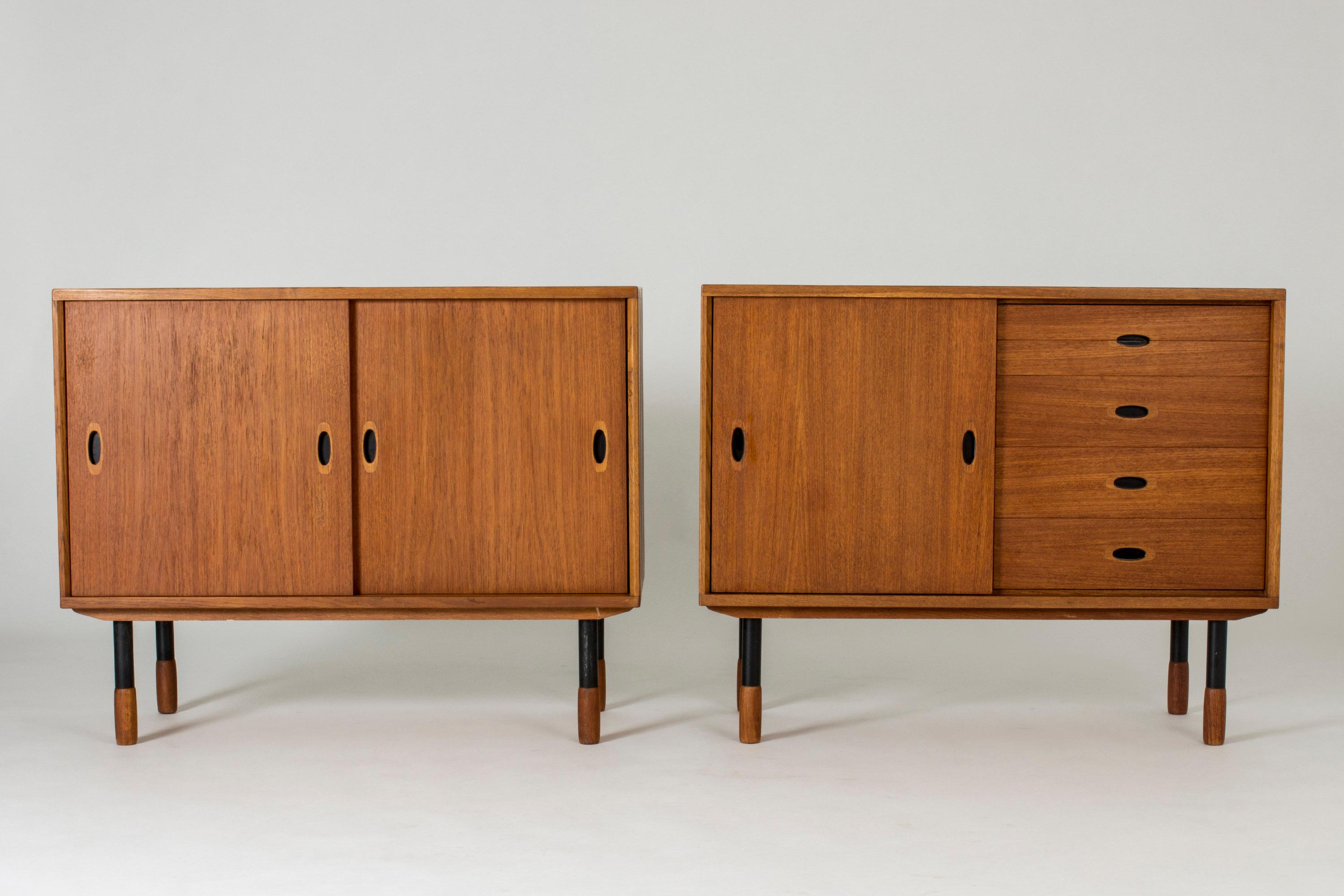 Pair of cool sideboards from Westbergs Möbler, made from teak with black lacquered metal legs. Chunky teak feet and details of black hollowed drawer handles. One of the sideboards has drawers on one side.