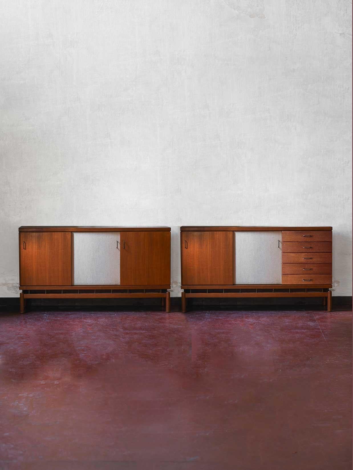 Pair of teak sideboards “La Permanente Mobili Cantù” with brass and fabric details by Ilmari Tapiovaara.
1 Storage unit with sliding doors and internal shelves
1 Storage unit with sliding doors, internal shelves and drawers.
Sold as set of 2.