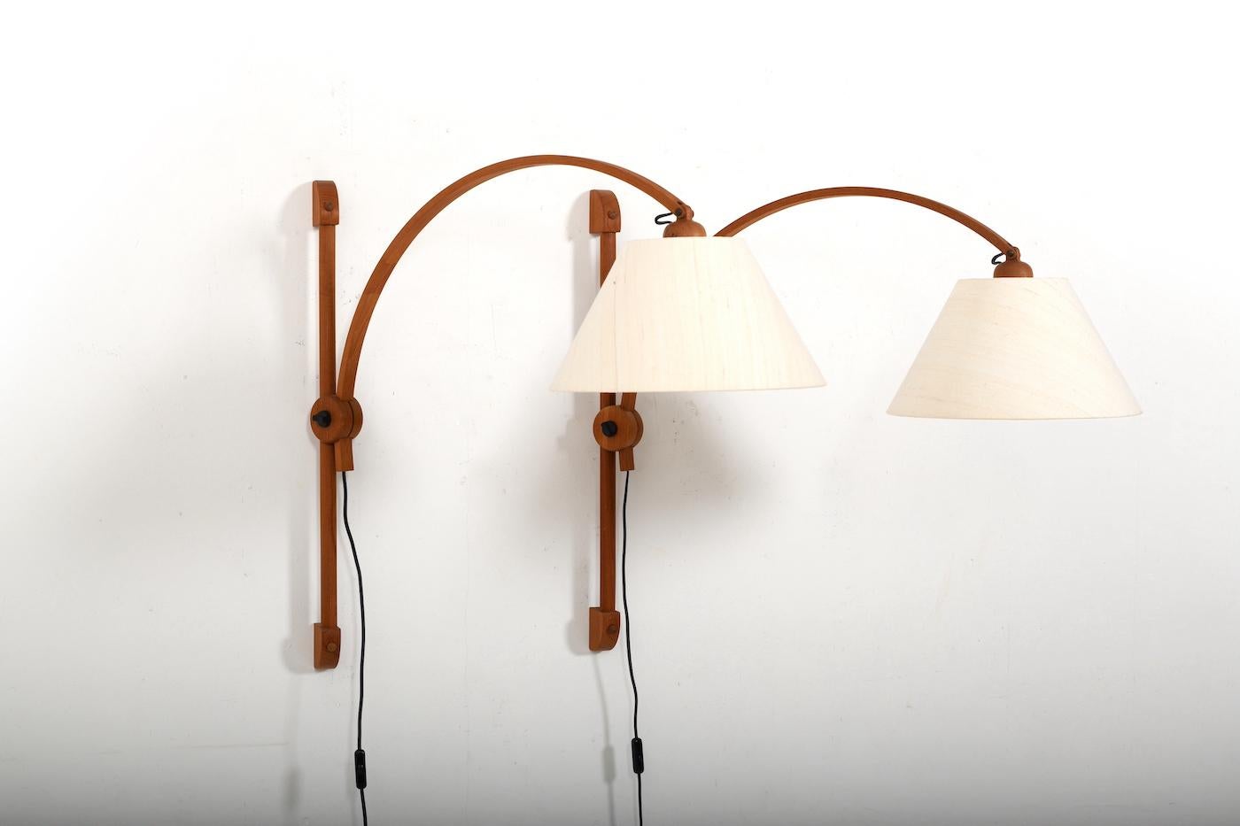 Pair of teak wall lamps by Domus Denmark 1970s. Lamp arms adjustable in depth and height. In top condition with original shades. Setprice.