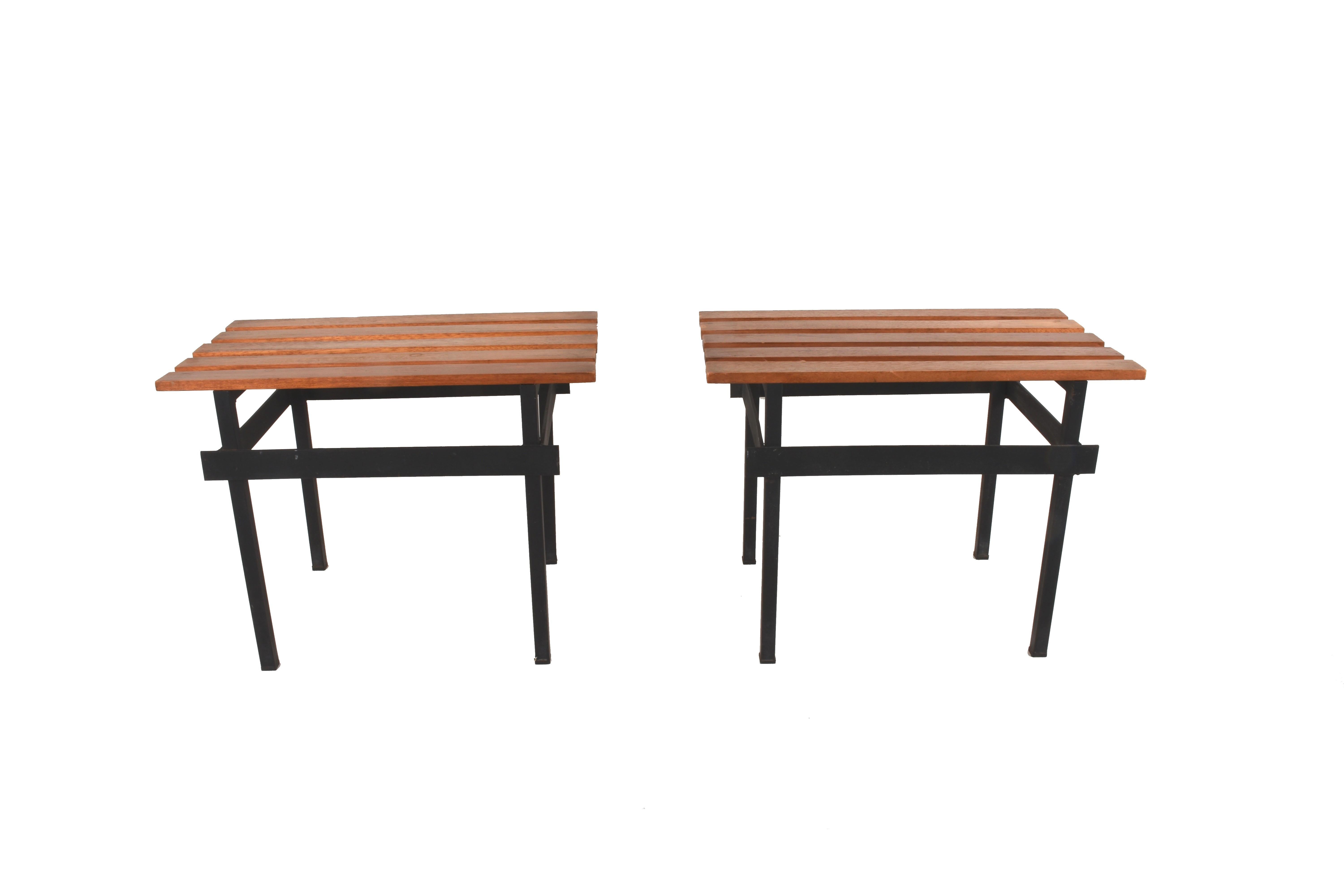 Set of two teak wood benches. The solid base in enameled iron, 1960s. Excellent design objects of the 1960s for the decoration of interiors, windows, lofts or simply to create a window.