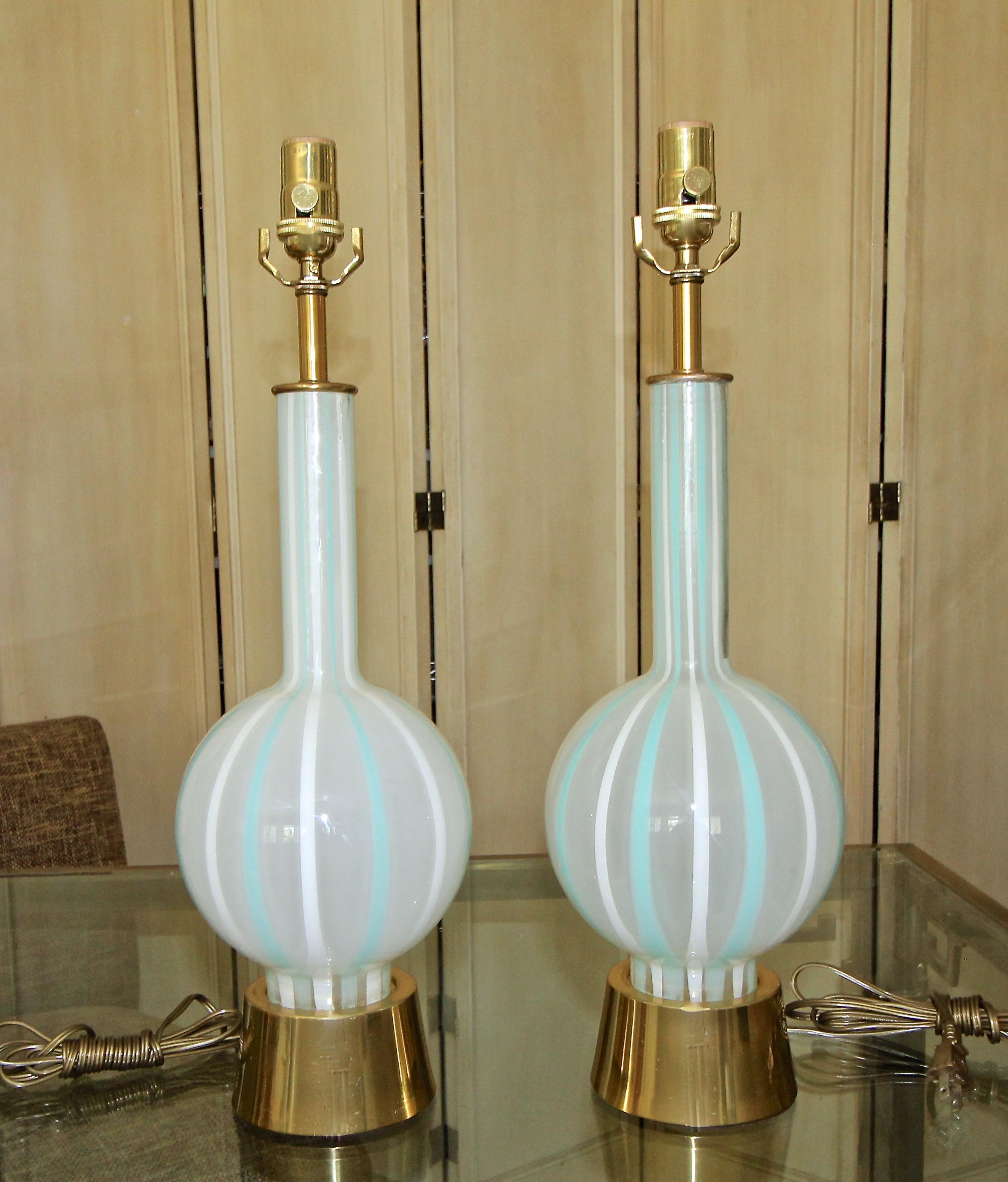 Pair of midcentury frosted glass with striped painted teal (aqua blue) and white table lamps, mounted on original brass-plated metal bases. Newly wired. The decorative lamps have an appealing fresh vibe, making them a great addition to a modern or