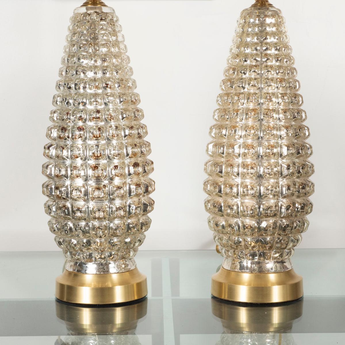 Pair of teardrop mercury glass lamps with faceted pattern.