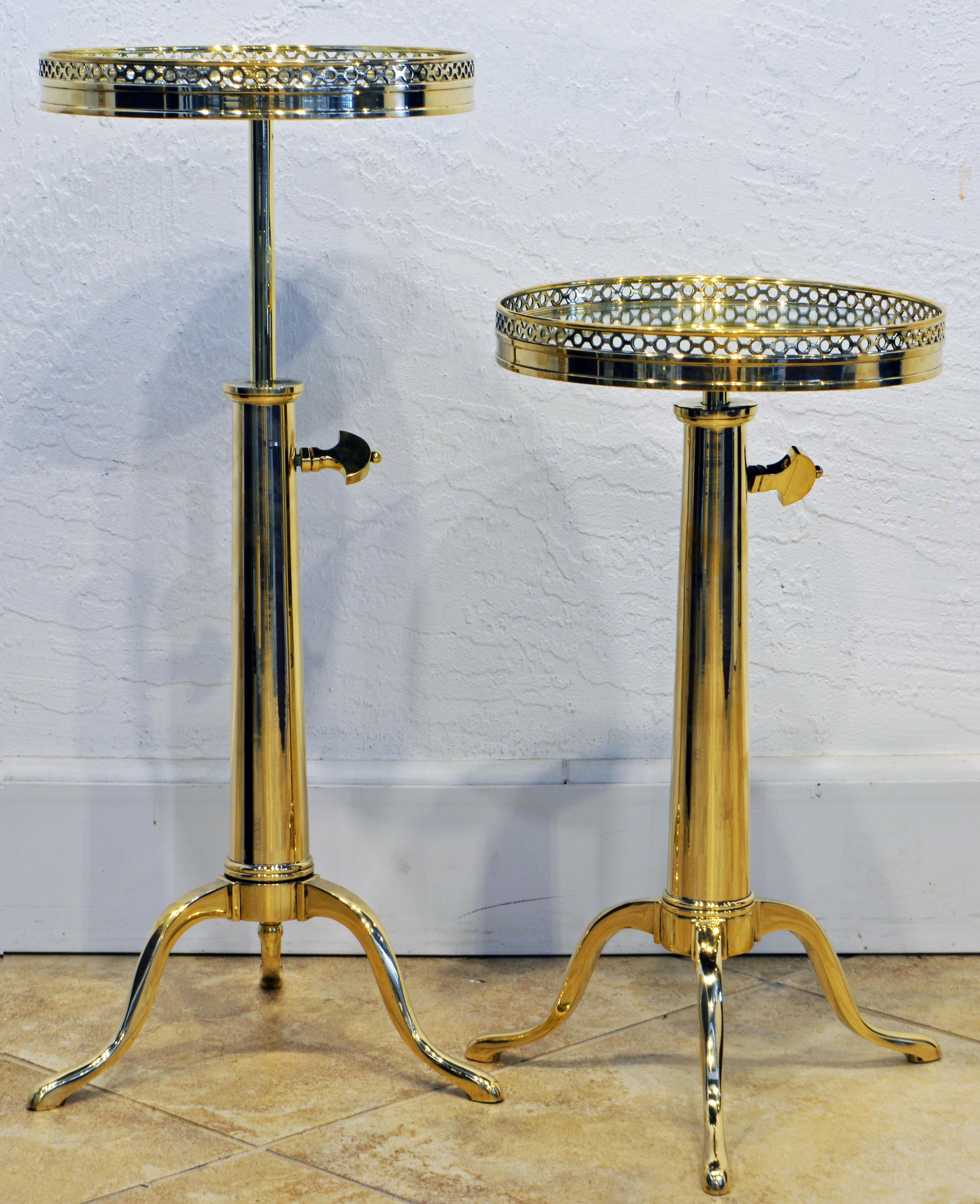 This pair of French Maison Toulouse telescoping brass occasional tables, dating to around 1970, feature circular pierced galleried tops with inset mirror supported by adjustable telescoping shafts and cabriole legs with pad feet. Measures: Height