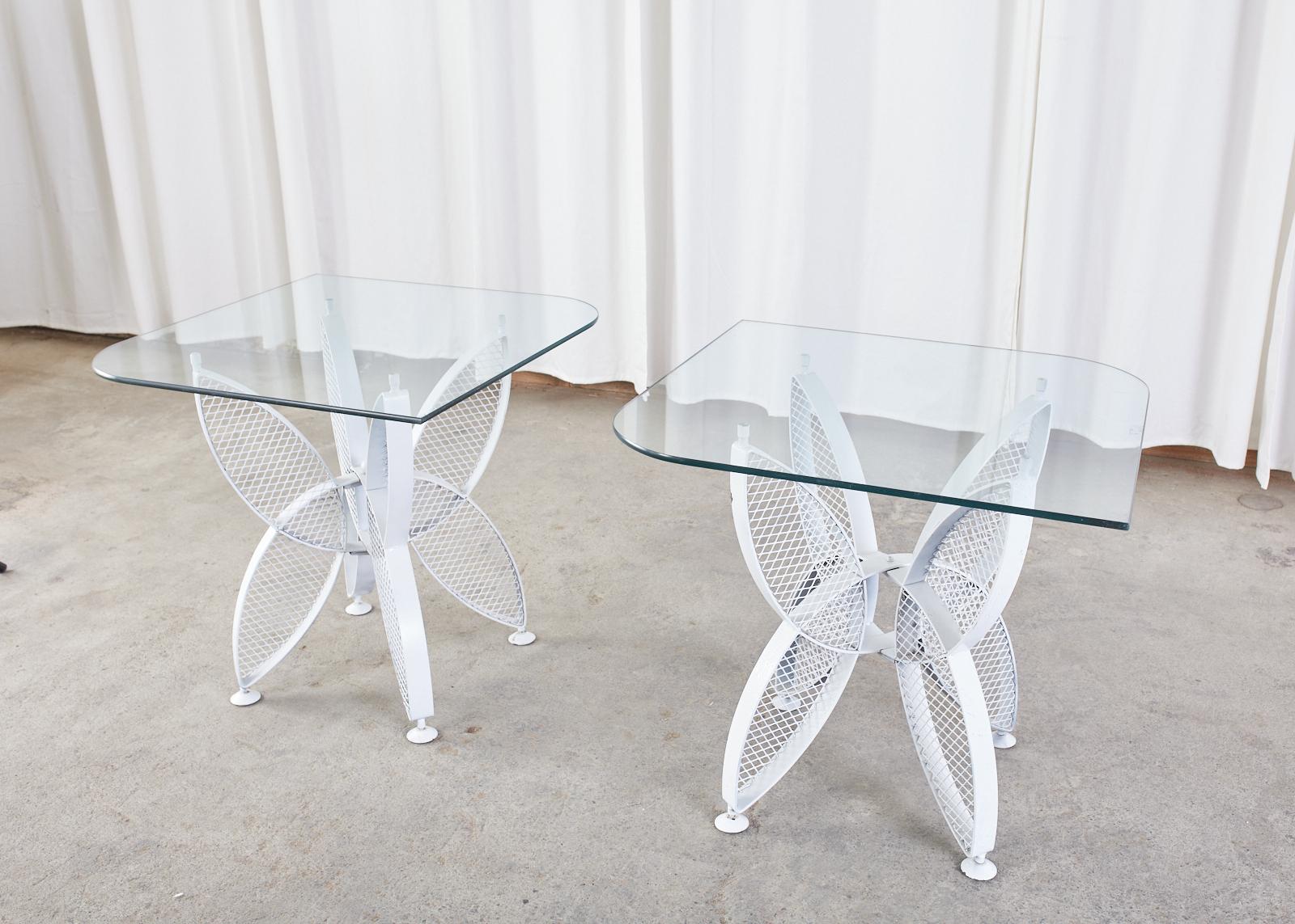 Mid-Century Modern iron butterfly drinks tables designed by Maurizio Tempestini for John Salterini. Sculptural styled painted wrought iron topped with glass panes having two rounded corners each. Each butterfly wing is inset with a perforated
