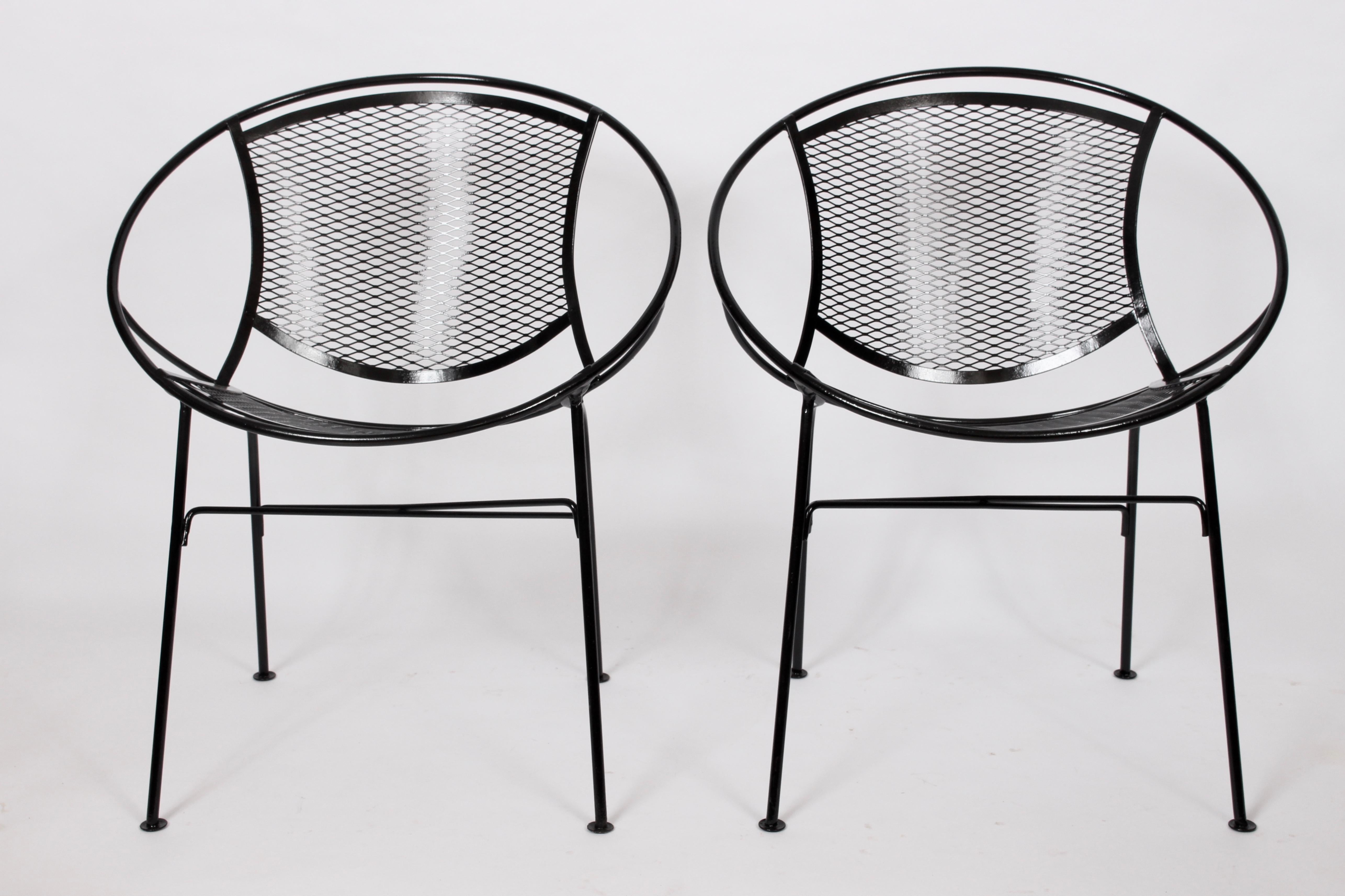 Original Maurizio Tempestini for Salterini black radar dining armchairs. Featuring a sculpted sturdy hoop framework in black enameled wrought iron and wire mesh. Indoor outdoor seating. American Mid-Century Modern. Classic. Comfort. Four available.