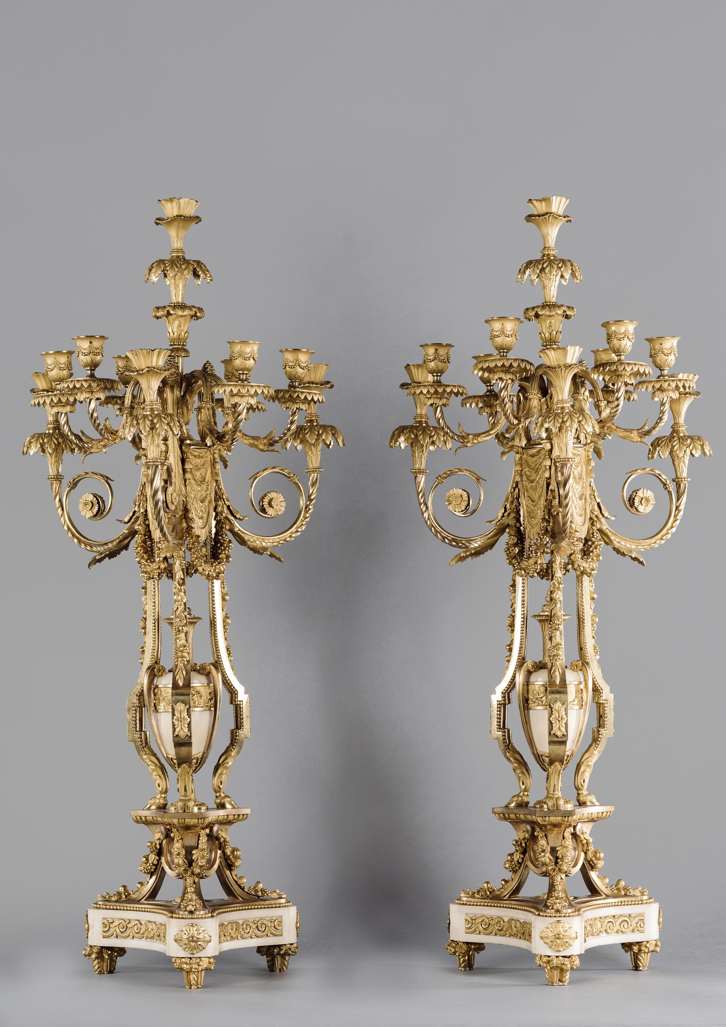 A Fine Pair Of Gilt-Bronze And White Marble Ten-Light Candelabra After The Model by Pierre Gouthière, by Henri Picard.

French, Circa 1870. 

The gilt-bronze variously stamped 'PP'.

This fine pair of candelabra with marble urns, masks and