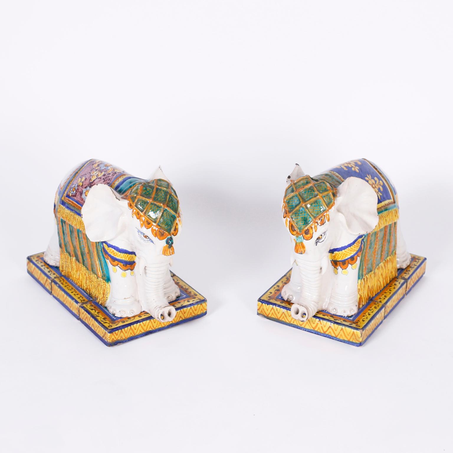 Terracotta elephants decorated and glazed sitting on three piece bases. Signed inside Casa Gonzales.